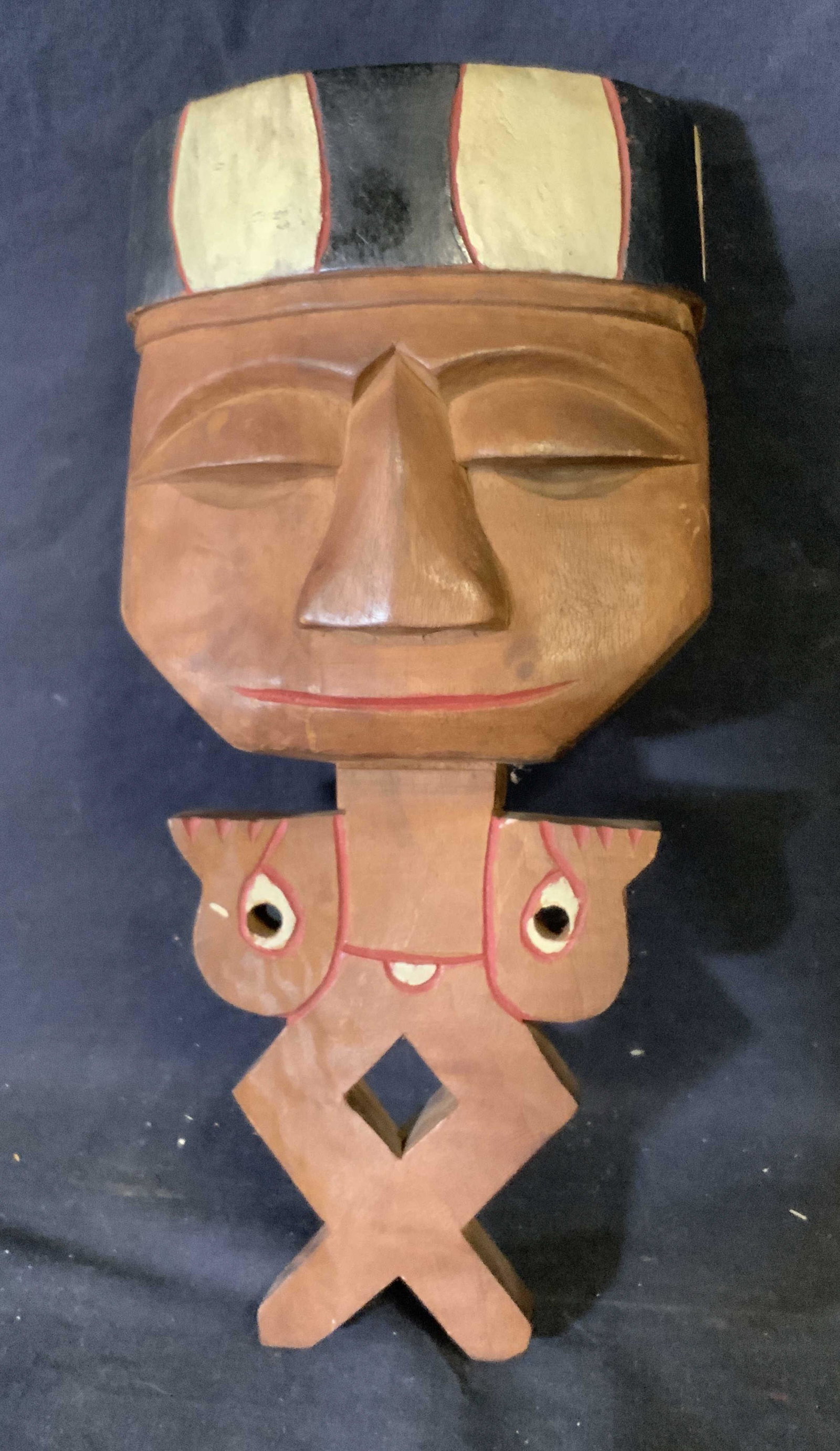 Hand Carved Wooden Wall Hanging Totem: Hand Carved wooden wall hanging totem, no apparent inscriptions or markings, subject a figure with a geometric body and enlarged head, wood painted red white and black, piece measures 12 inches at tal