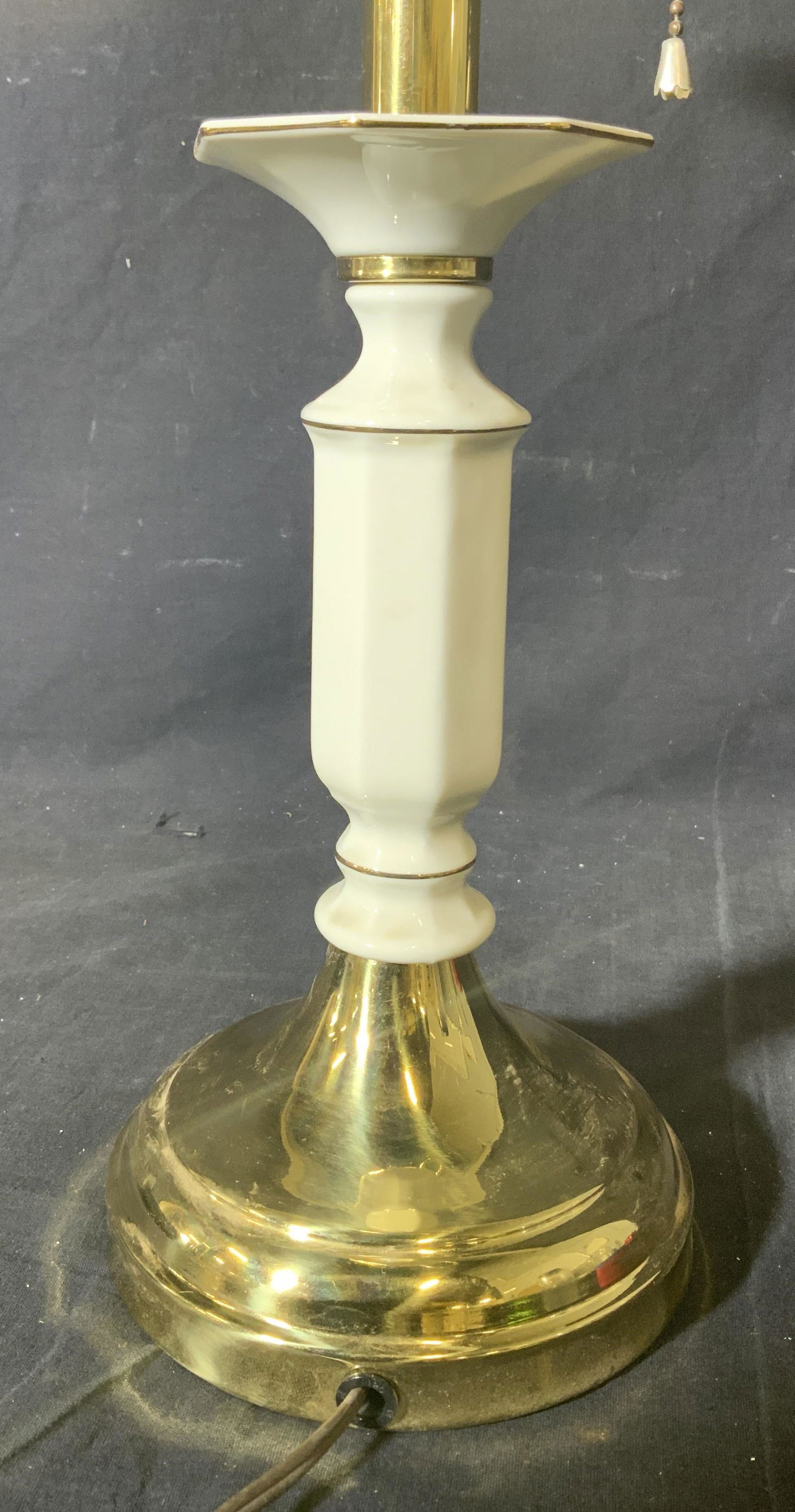 Vintage Brass & Porcelain Lamp: Lamp appears to be vintage. Piece has gold toned circular base. Top half is also gold toned, each appears to possibly be brass. Portion of lower half is cream toned & porcelain. Lamp has 2 bulb socket