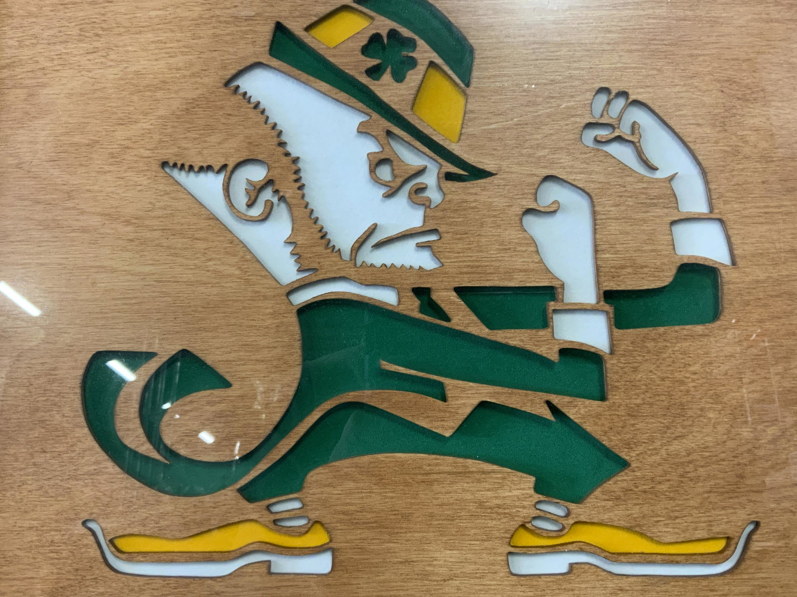 Signed ERIK WARREN Fighting Irish Mascot Wood Art: Framed UNIVERSITY OF NOTRE DAME wood art. Signed Erik in lower right corner. Piece is framed and set beneath glass, piece has not been inspected outside of frame. Depicts the mascot of NOTRE DAMEs ath