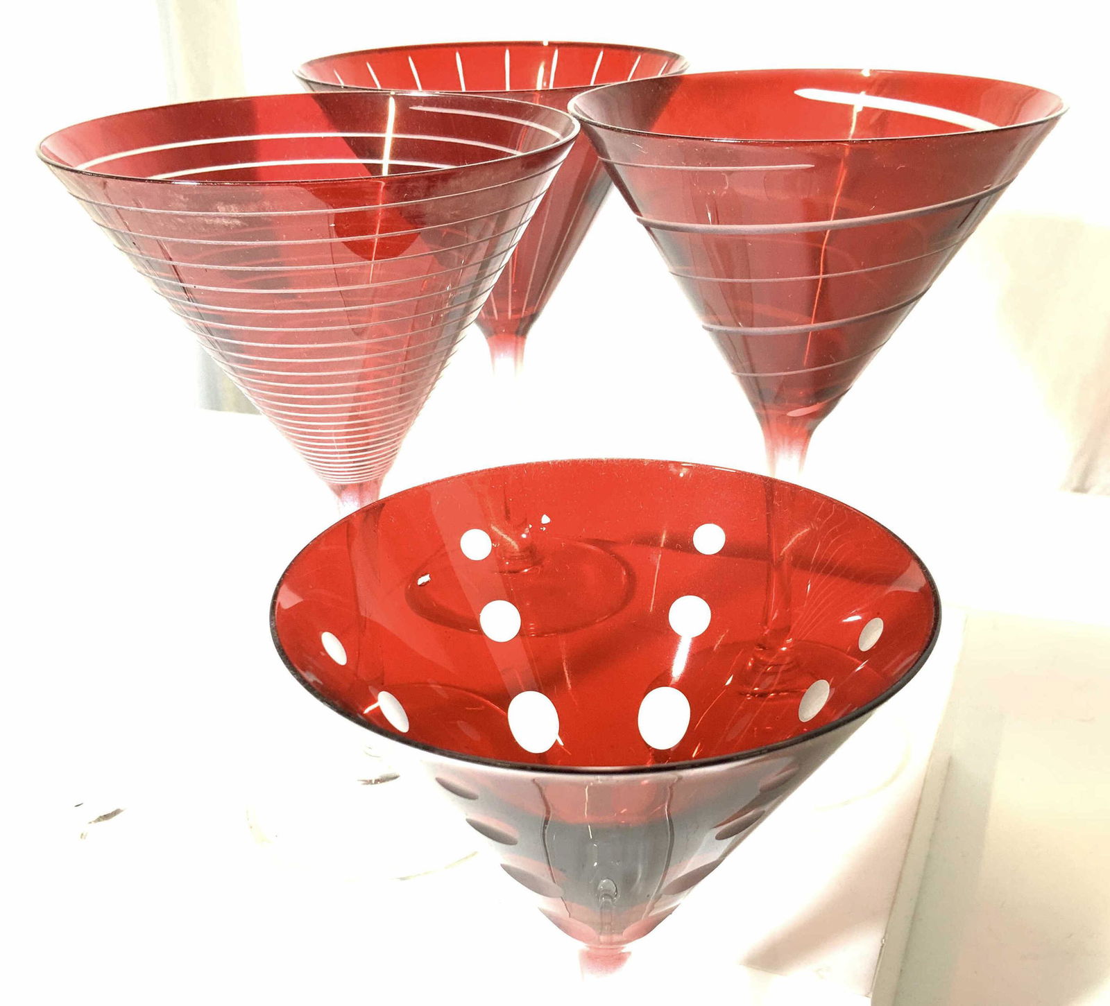 Set 4 Ruby Red Cocktail Glass Stemware: Modern Ruby Red Cocktail Glasses with Geometrical Patterns. Clear glass base and stem with deep Ruby red presentation. 7.25 in. Ht, 4.75 in wide. Mild discoloration consistent with use and exposure. T