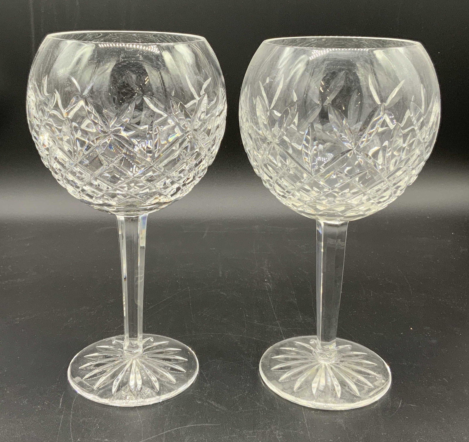 Pair WATERFORD Cut Crystal Stemware Goblets: Undersides of each goblet is marked WATERFORD. Each goblet is cut crystal. Each measures approx 8 inches tall 4.5 inches wide. Goblets, wine glasses, stemware, cut crystal, Waterford Crystal, Waterfor