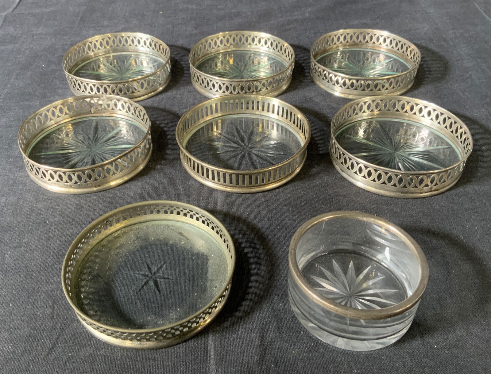Lot 8 Vintage Sterling Silver & Glass Coasters: Lot 7 Vintage Sterling Silver & Glass Coasters, inscriptions read ‘Sterling JH 200’, ‘Sterling 19’, ‘Sternauware’, ‘Sterling’, Sternauware coaster is not sterling silver, smallest coas