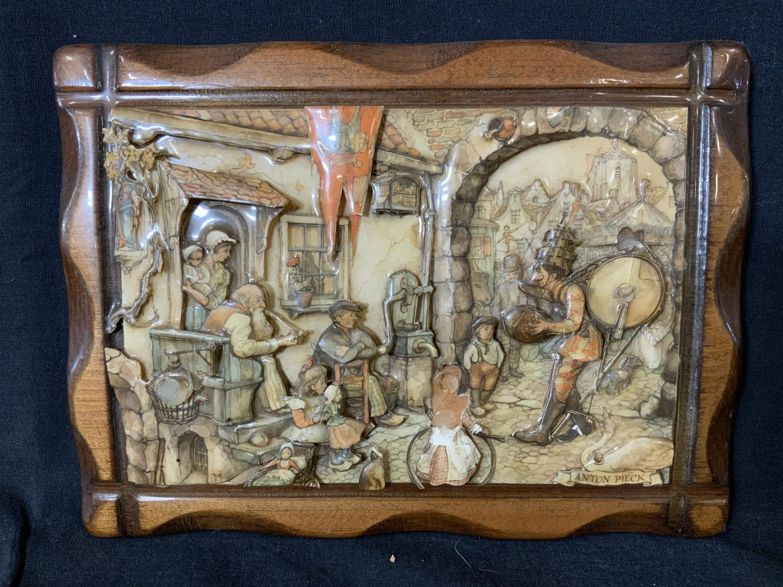 ANTON PIECK The Street Musican 3D Artwork: ANTON PIECK The Street Musican 3D Artwork, inscription to lower right reads ‘Anton Pieck’, subject people sitting in front of a home listening to a performer, measures 7 7/8 x 10 5/8 inches, some 