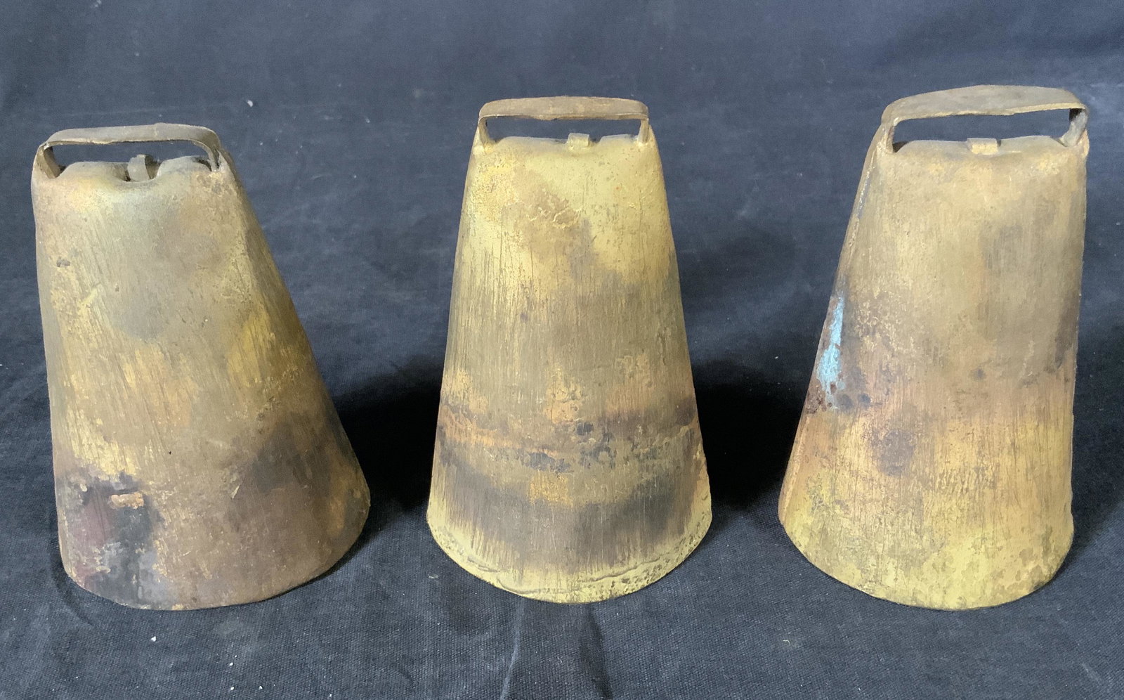 Set 3 Vintage heavy weight Cowbells, Brazil: Set 3 Vintage Cowbells, Brazil, label to pieces reads ‘Made in Brazil’, remainder of label in Portuguese, all cowbells measure 4 1/4 x 2 3/4 inches at widest point, some tarnishing and surface wea