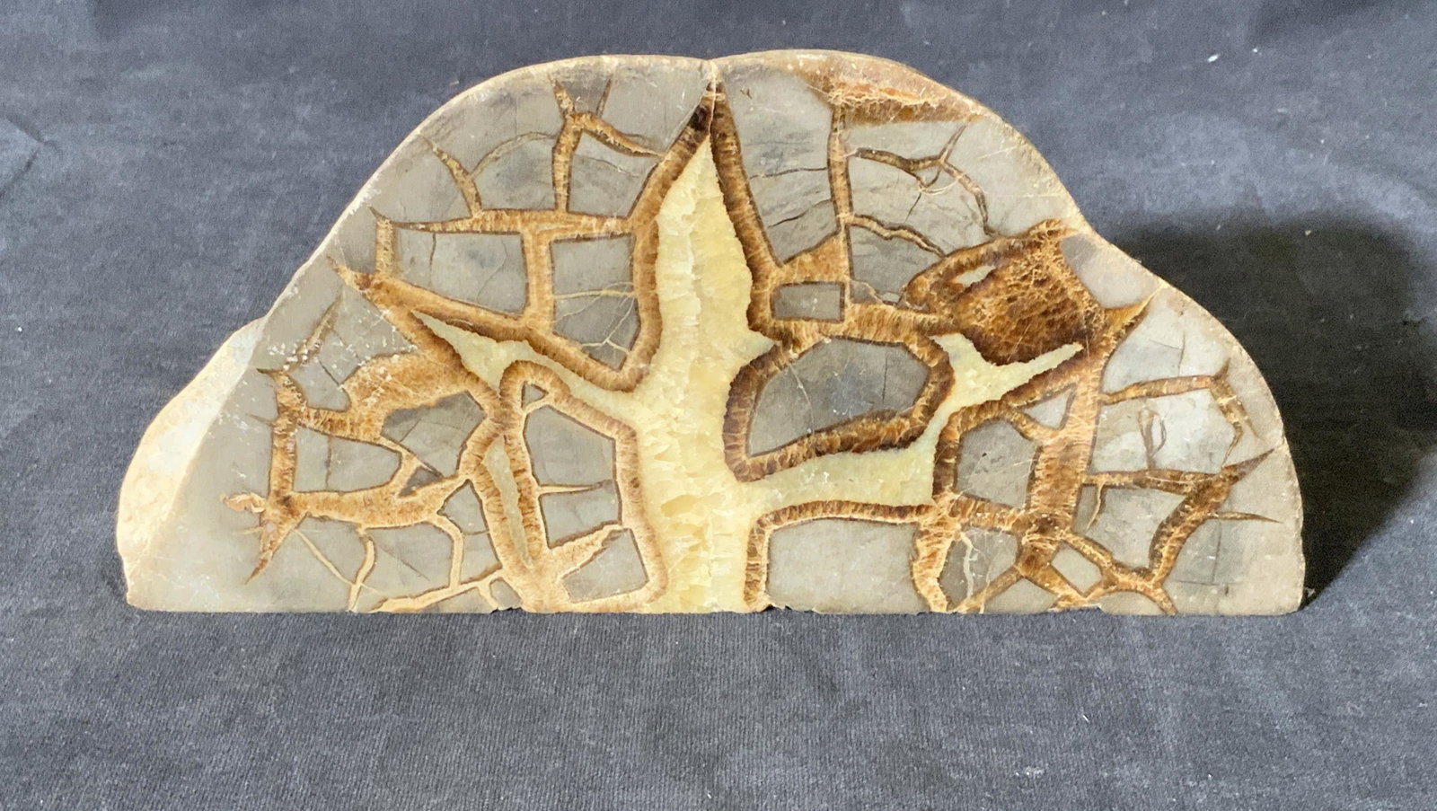 Stone Geode Paperweight: Stone Geode Paperweight, no apparent inscriptions or labels, subject a half geode consisting of grey brown and tans sections, piece measures approximately 7.5 inches wide and 3.5 inches tall, in good 