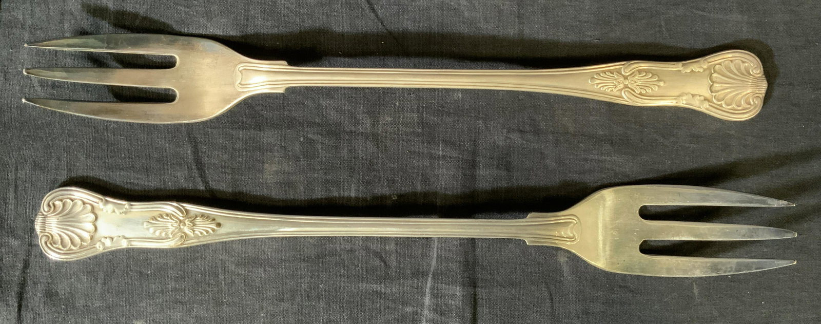 Pair Vintage Silver Plated Serving Forks: Pair Vintage Silver Plated Serving Forks, c 1960’s, mark reads ‘PS Co’, both measure 13 1/8 inches long, some tarnishing and surface wear to metal, Property of Janine Metz estate, social secreta