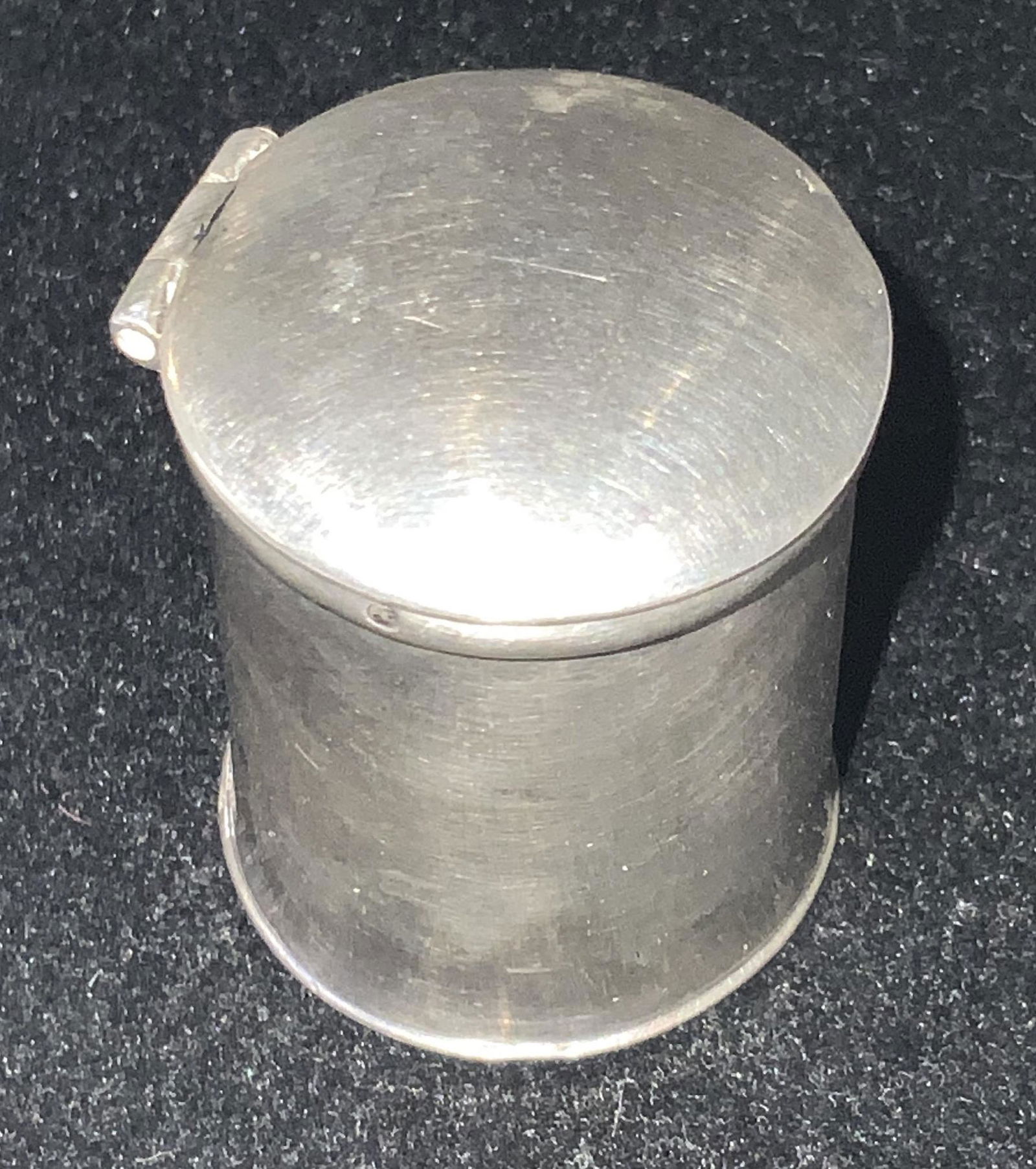 Vntg Sterling Silver Lidded Cylindrical Pill Box: A vintage, possibly antique, sterling silver cylindrical hinged pill box. The lid and base fit together seamlessly. Polished silver exterior. The exterior has a hallmark on the side. Piece tested posi