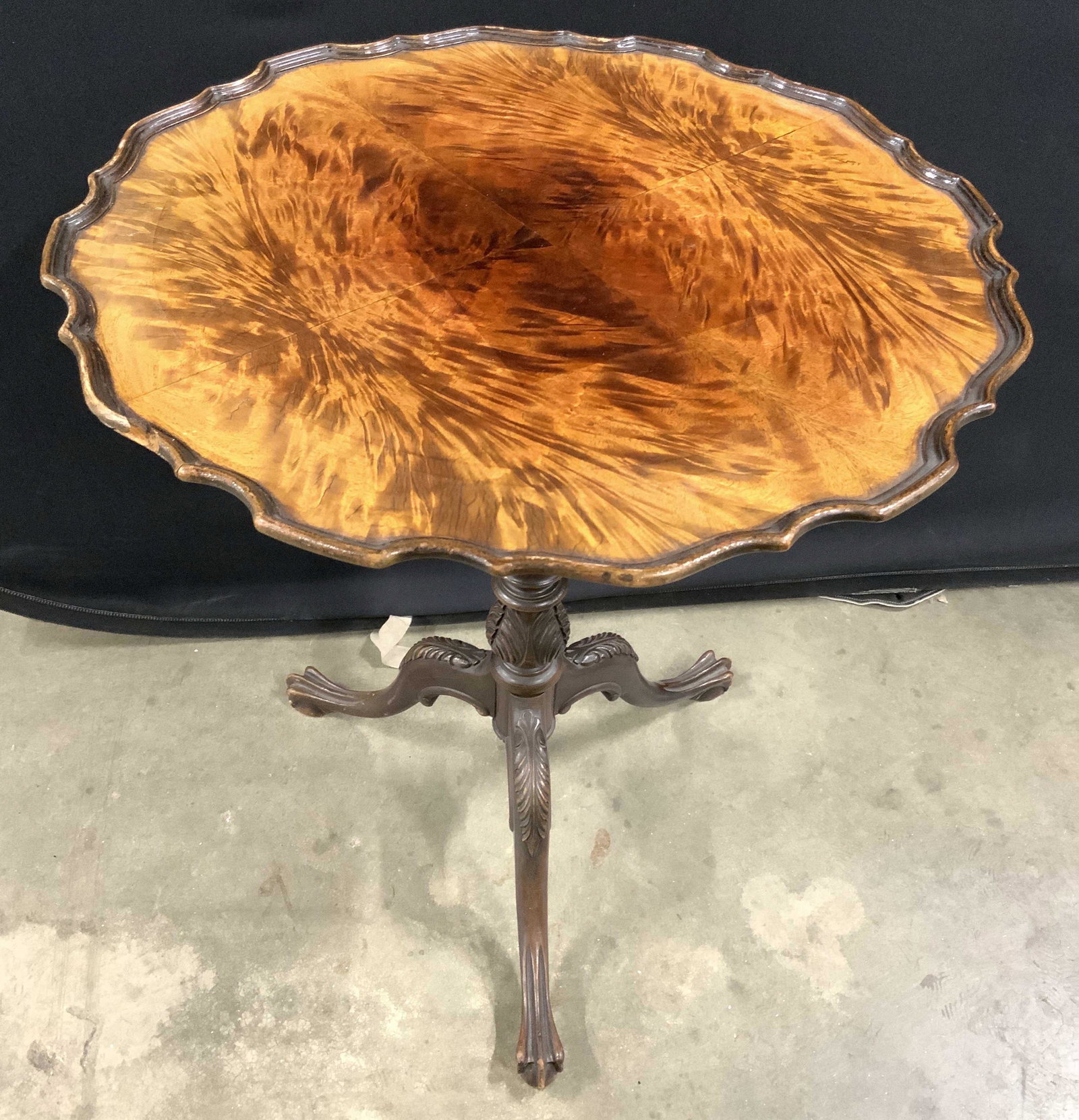 FERGUSON BROS Vintage Wooden Pie Crust Table: Underside of tabletop has tag which reads FERGUSON BROS MFG CO. Table has has carved wooden pie crust style top. Table is pedestaled. Pedestal has intricately carved wooden detail. Piece measures appr