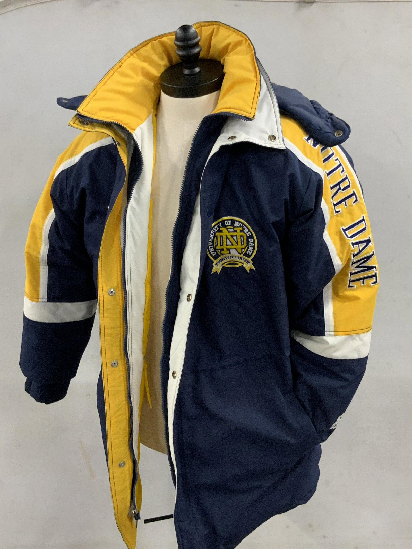 REGIS PHILBIN Duck Down Coat, Starter Brand: A duck down blend jacket once owned by Regis Philbin. Blue, yellow, white hued in color. Interior is fully lined. Jacket has two exterior lined pockets. Two interior pockets as well. One interior pock