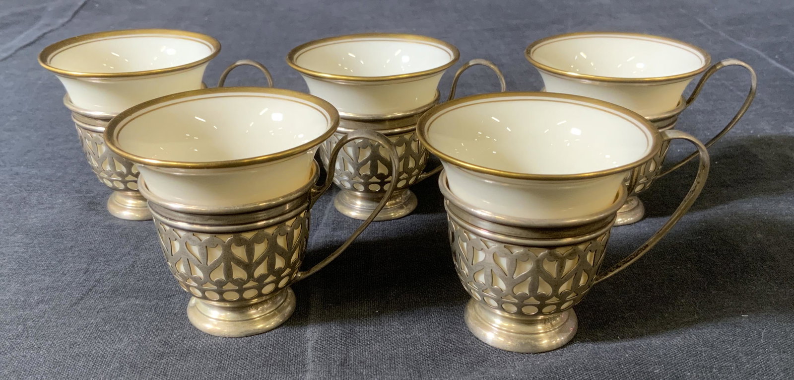 Set 5 LENOX Teacups & GORHAM Sterling Holders: Set 5 Vintage LENOX Teacups & GORHAM Sterling Holders, c 1906-1930, inscriptions read ‘Lenox’ and ‘Sterling A5549’, cups measure 2 1/8 inches tall x 2 1/4 inches in diameter, cup holders measu