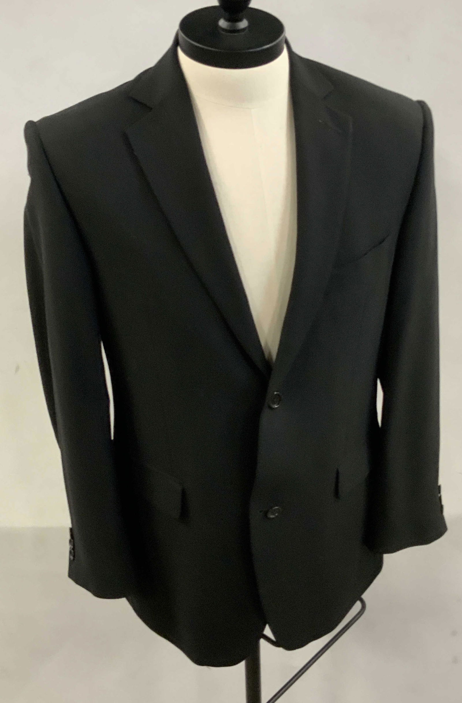 REGIS PHILBIN Guy Laroche Italian Wool Blazer: A black blazer once worn by Regis Philbin. Piece has three exterior pockets and secures with black buttons. Interior tags read GUY LAROCHE, MADE IN ITALY, SUPER 120 WOOL, ITALIAN FINE CLOTH. Approx le