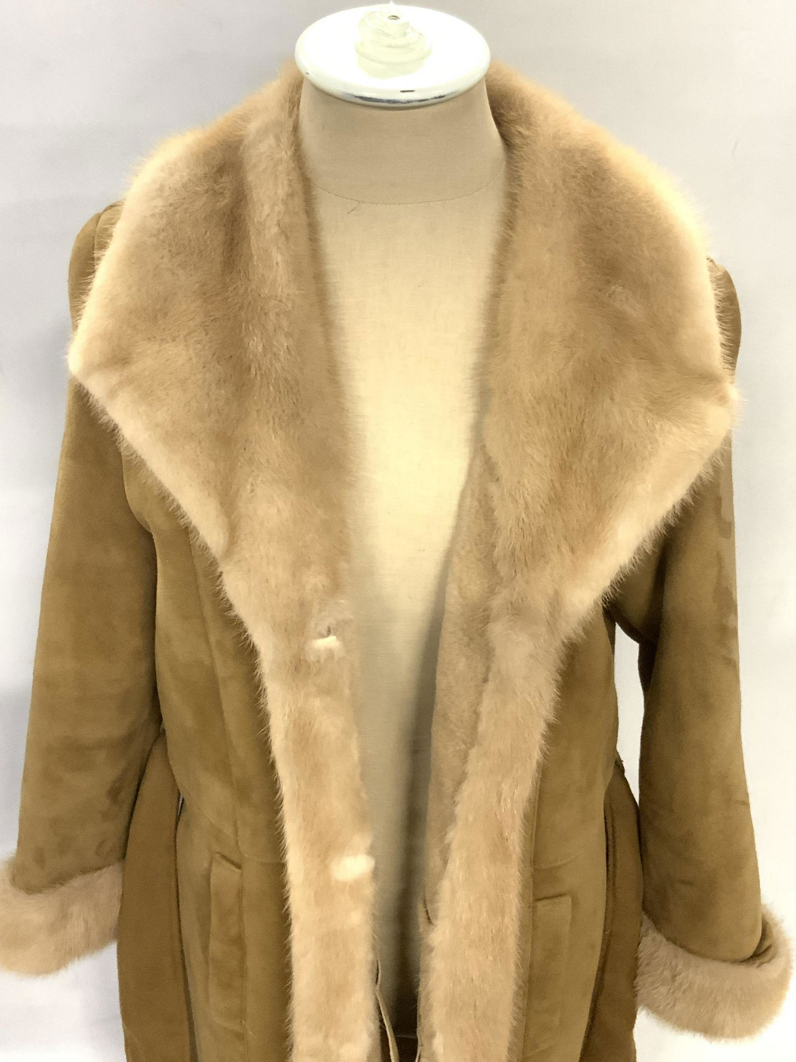 JOY PHILBIN Inochi Lamb & Mink Fur Coat: A brown hued lamb and mink fur coat once owned by Joy Philbin. Two exterior pockets. Piece secures with intricate open metalwork buttons. Piece also possesses a fabric belt. Interior tags read INOCHI,