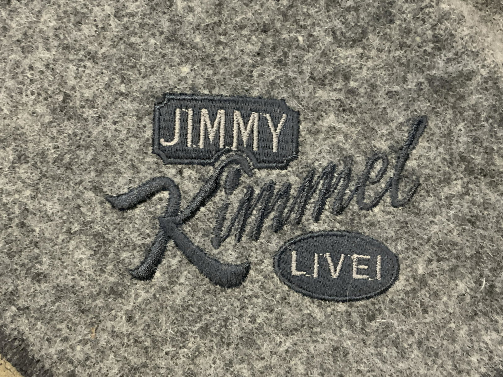 REGIS PHILBIN JIMMY KIMMEL LIVE Throw Blanket: Throw blanket is embroidered JIMMY KIMMEL LIVE. Piece is grey toned. Includes black and silver toned ribbon. Piece measures approx 84 inches long 67 inches wide Philbin memorabilia, Regis Philbin coll