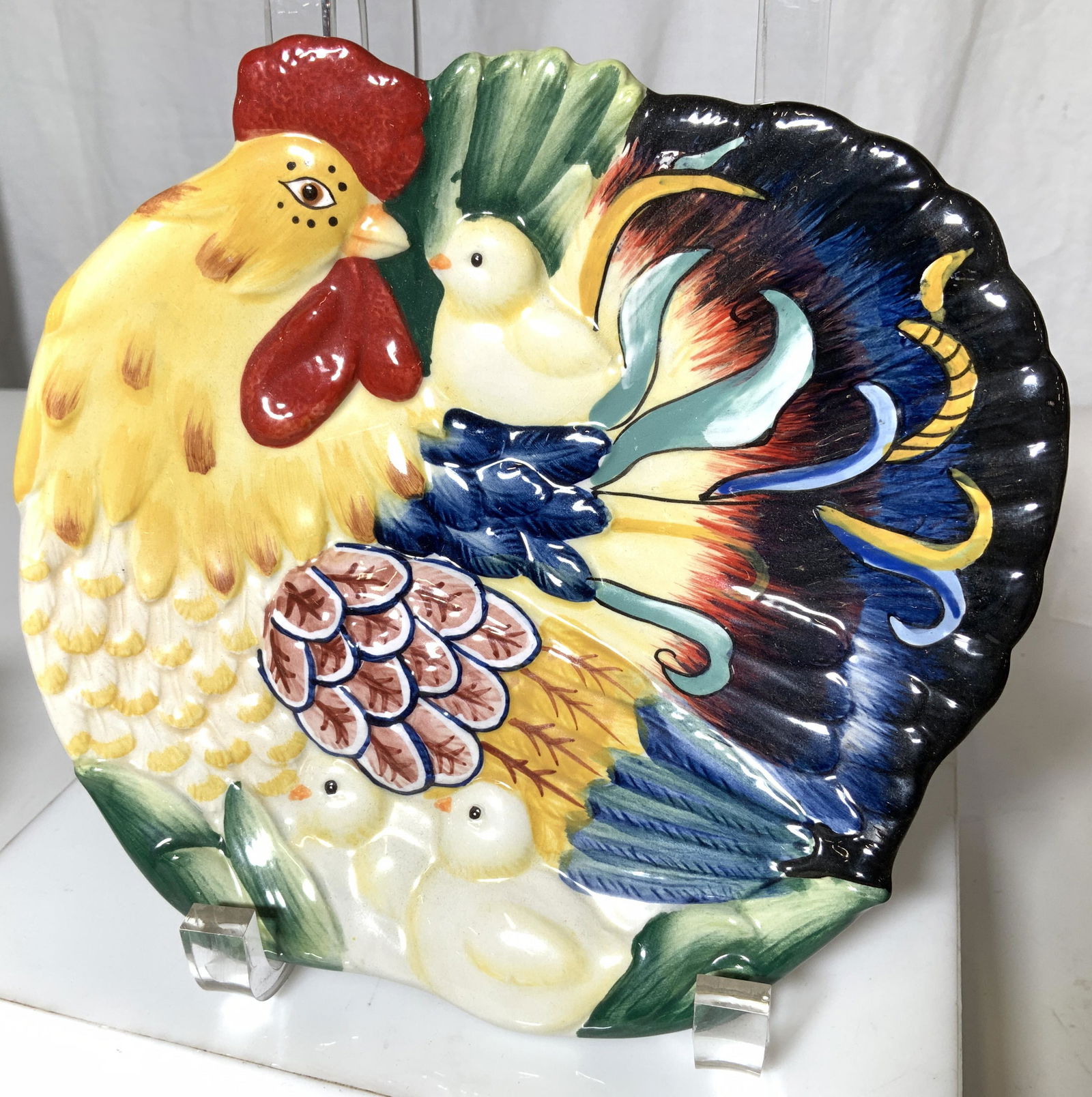 FITZ & FLOYD RICAMO Snack Plate Set 2: Ceramic Rooster Condiment Bowl and Snack plate, embossed hand painted Roister Motif, Colored with vibrant Blues, saffron, Red and green. Both pieces Hallmarked. Plate measures 7.25 in. Bowl with roost