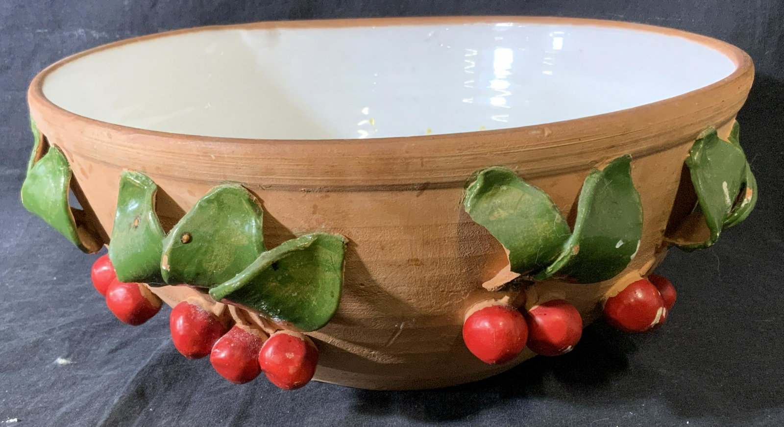 Vintage Handmade Earthenware Bowl: Vintage earthenware bowl, bowl is hand painted, decorated with cherries and leaves. Bowl well is glazed and has been colored white, possibly enamel. Measures approx 5 inches H, and 11.5 inches in diam