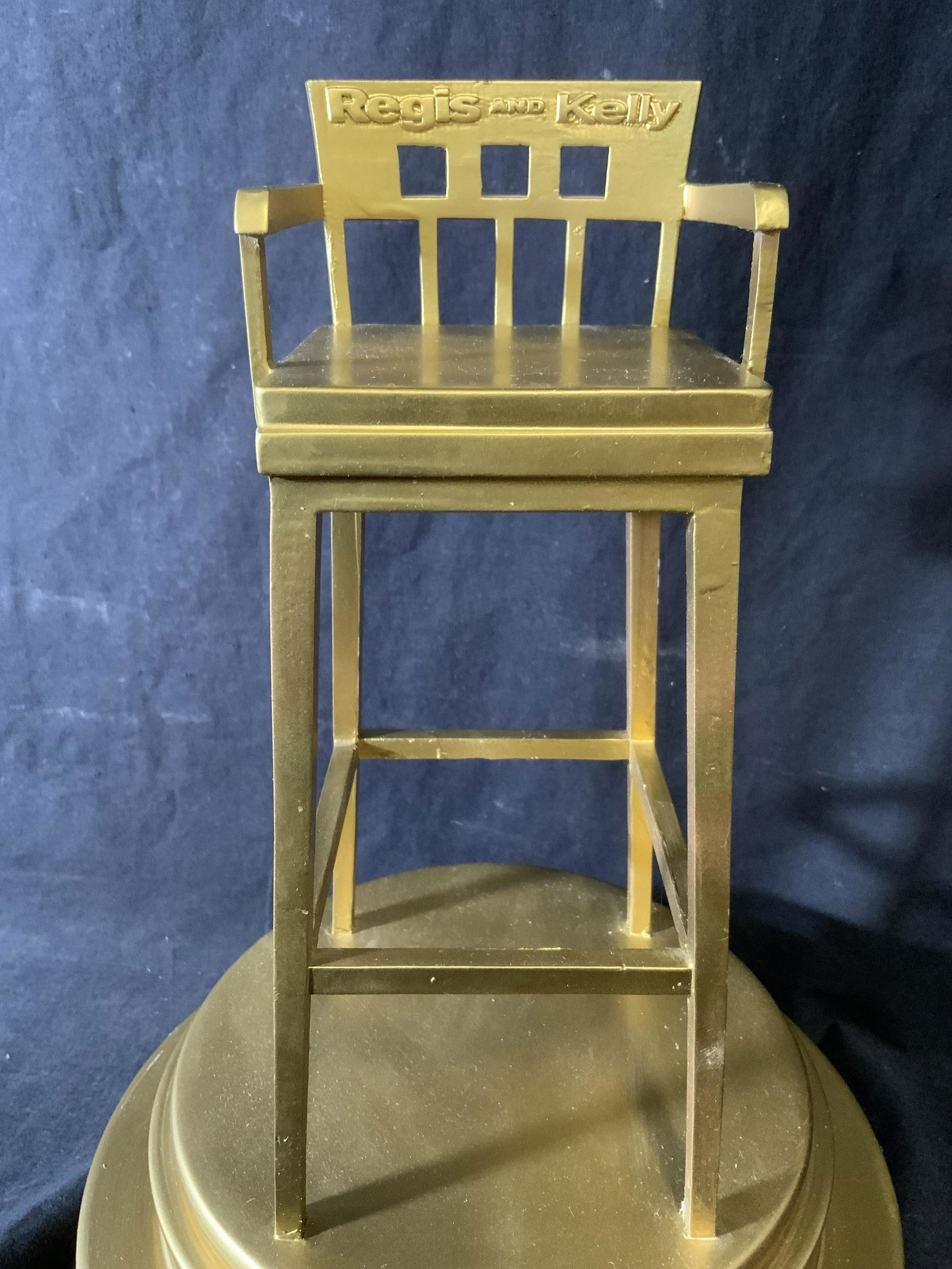 REGIS PHILBIN THE RELLY AWARDS Trophy: THE RELLY AWARDS trophy, appears to be crafted from a composite material, possibly resin. Trophy reads as JOY PHILBIN BEST GUEST CO HOST 2003, THE RELLY AWARDS, REGIS AND KELLY. The trophy has been pa