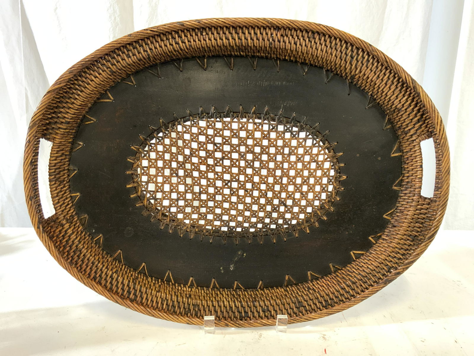 Vintage Woven Caned Wicker Serving Tray: Serving tray is caned and appears to have woven wicker structure. Piece has handles on each side. Serving tray has light and dark brown tones. Piece measures approx 18.5 inches long, 14 inches wide. S