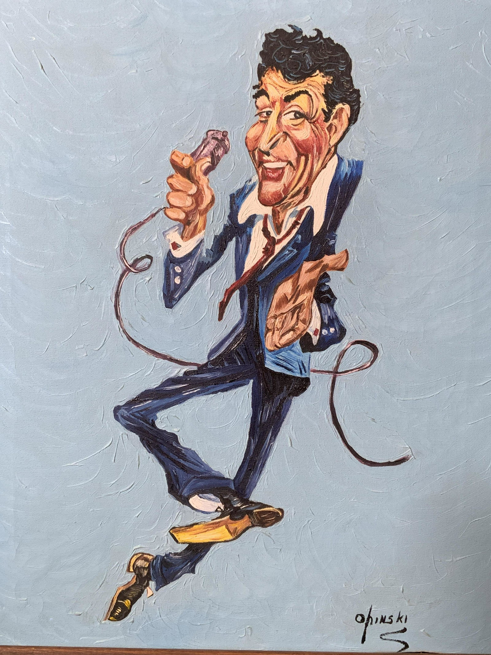 Opinski Signed Painting of Dean Martin: Opinski signed painting of Dean Martin, signature to the lower right corner reads ‘Opinski’, subject a caricature of Dean Martin in a blue suit with a red tie holding a microphone, thick impasto b
