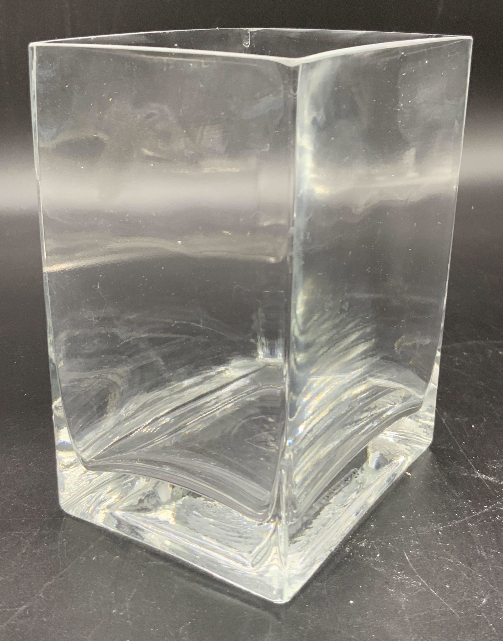 SILVER BAY Signed Square Form Glass Vase: A colorless square form glass vase. Underside has a sticker reading SILVER BAY. Some surface wear, chip. Approx. 5.5H x 4W in. This item was generously donated by Regis Philbin’s family and was the 