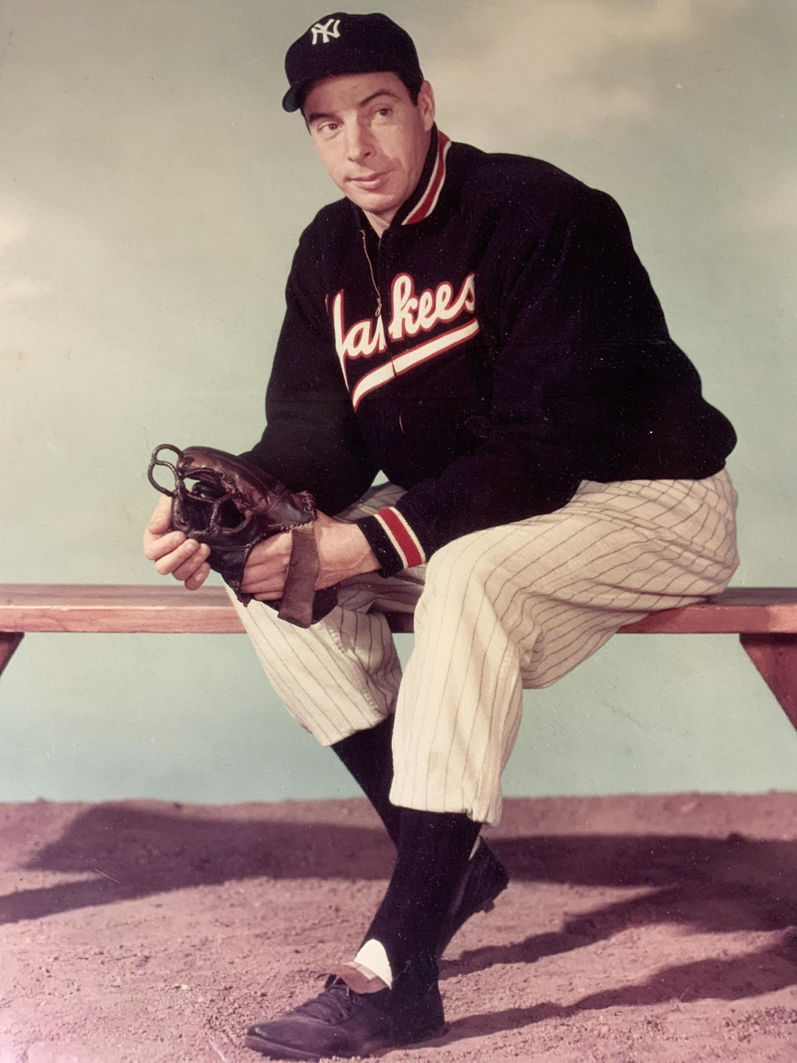Framed Photograph of Joe DiMaggio: Framed Photograph of Joe DiMaggio, label to reverse reads ‘Wade Max Art Gallery’, subject a man seated on a bench, measures 18 x 15 inches, wooden frame, some surface wear to frame, professionally