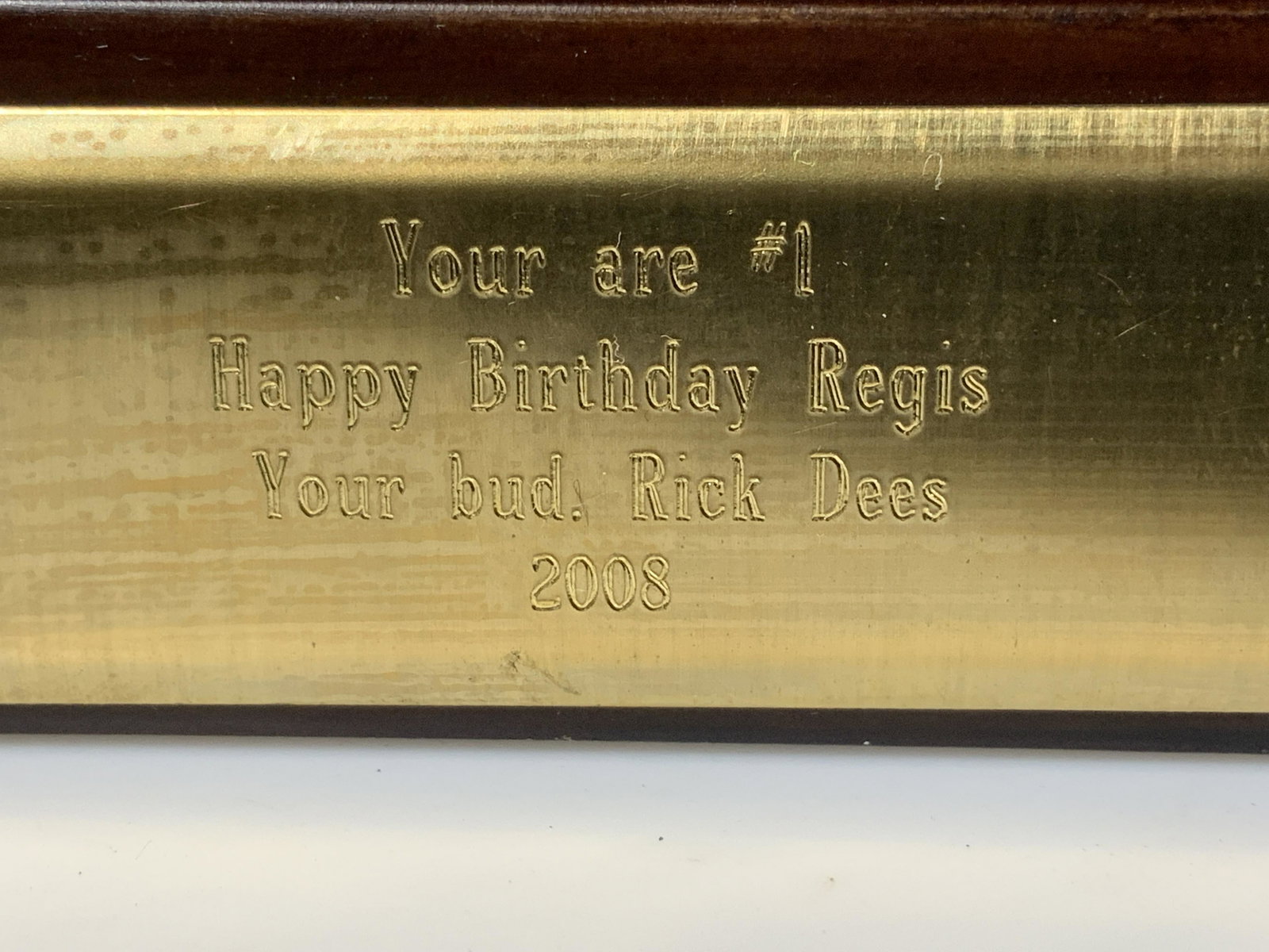 Regis Philbin BDay Plaque From Rick Dees: Rick Dees Radio Jockey, VO artist and entertainer , gifted a plaque with trophy to Regis Philbin. Plaque base remains with brass etching that reads ‘ You are #1 Happy Birthday Regis Your bud, Rick D