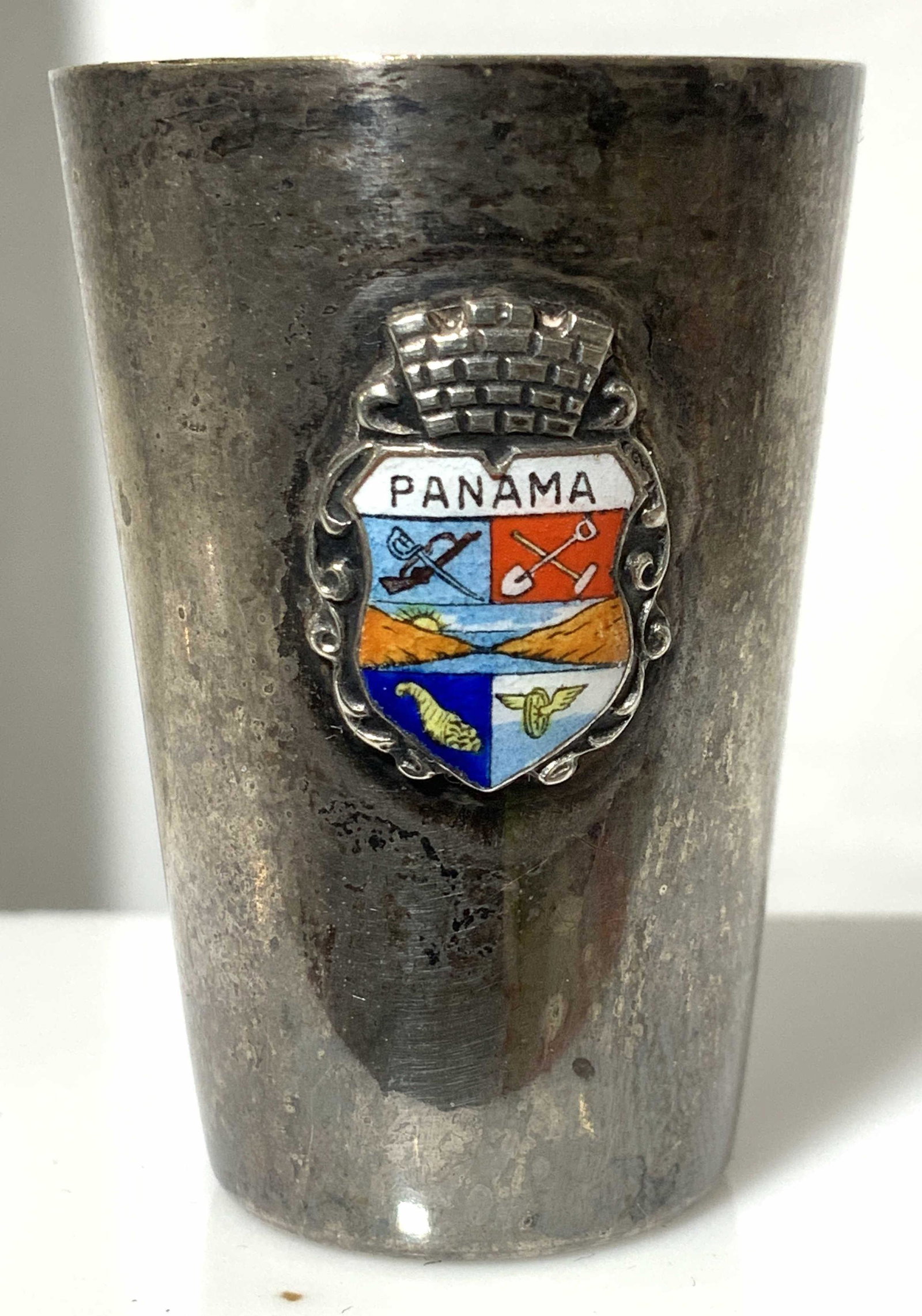Regis Philbin Silver Toned Panama Shot Glass: Owned by Regis Philbin, this is a metal shot glass souvenir with Panamanian Crest , reads Panama, possibly a lower grade silver plate. 1.75 in ht. This item was generously donated by Regis Philbin’s