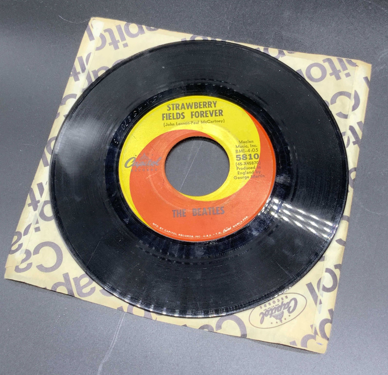 Vntg THE BEATLES Vinyl 45 Record, Penny Lane: A black vinyl 45 record. Obverse reads: Strawberry Fields Forver, John Lennon-Paul McCartney, The Beatles. Obverse reads: Penny Lane, John Lennon-Paul McCartney, The Beatles. Piece is contained in wha