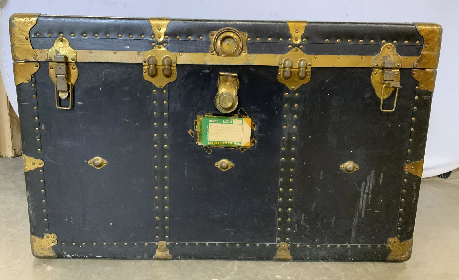 Vintage BINGHAM TRUNK CO Trunk: Vintage steamer trunk. Leather is secured to trunk with brass nails, brass clasps secure lid. Label on lid reads as TRADE MARK BINGHAM TRUNK CO. MAKERS BUFFALO NY, GUARANTEED 5 PLY CONSTRUCTION, 3 PLY