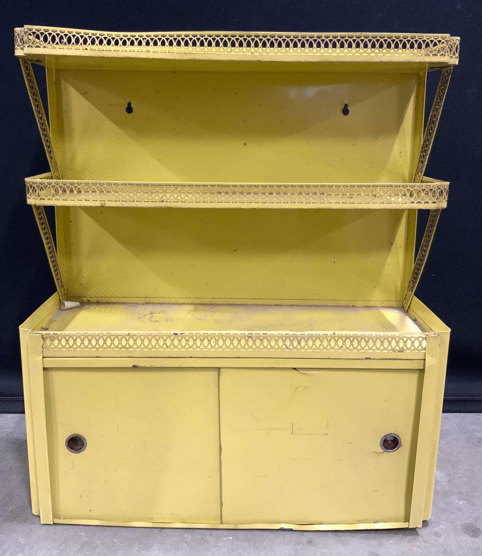 Antique Painted Metal Wall Shelf: Wall shelf is antique. Piece is metal, possibly tole. Piece has 3 shelf areas with gallery. Lower half has sliding door detail. Wall shelf, spice rack, metal wall shelf, antique metal wall shelf, anti