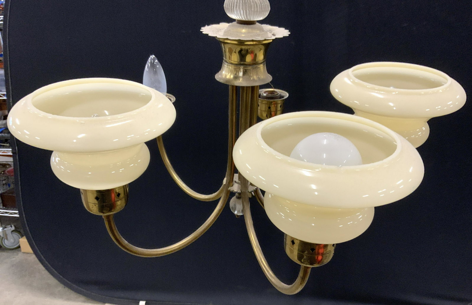 Vintage Brass 5 Arm Chandelier: Chandelier is gold toned and brass. Piece has 5 arms. Chandelier is vintage possibly antique. Piece includes 3 cream toned glass shades. Brass chandelier, chandelier, vintage chandelier, five arm chan