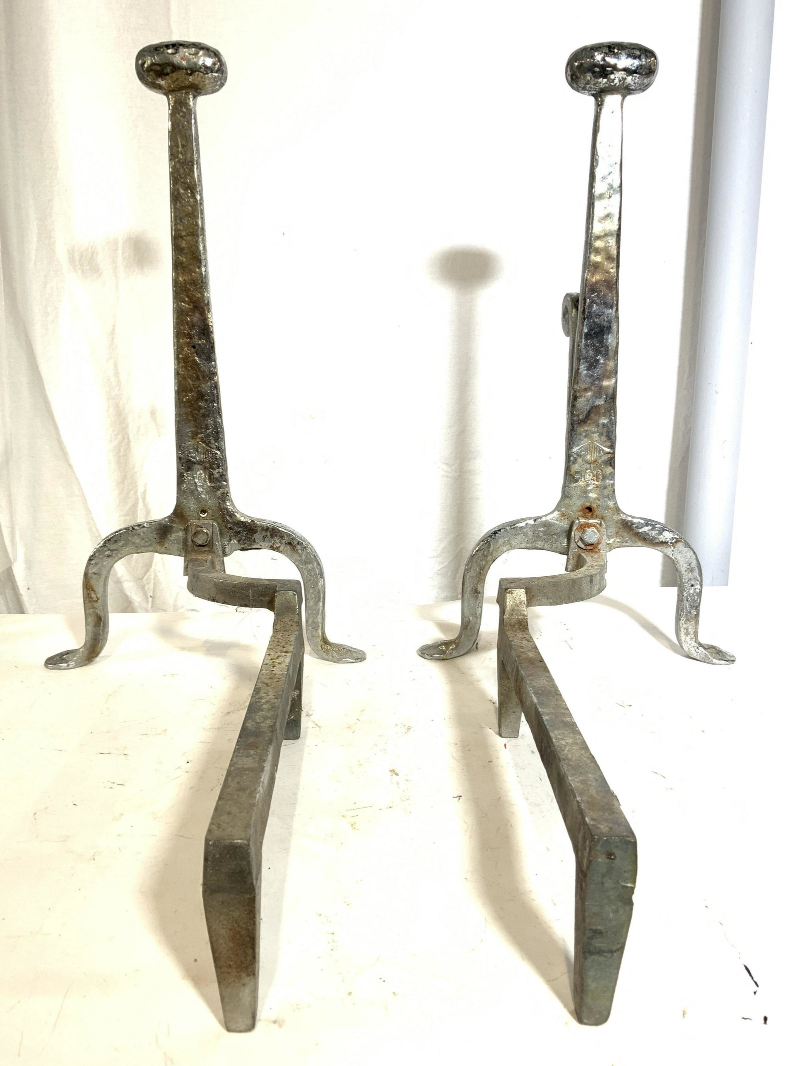 Vintage Signed Metal Fireplace Andirons: Andirons are vintage. Each are signed Illegibly. Each are silver toned, possibly iron, possibly pewter. Each measures approx 21 inches tall 12 inches wide 18.5 inches deep. Andirons, fireplace accesso
