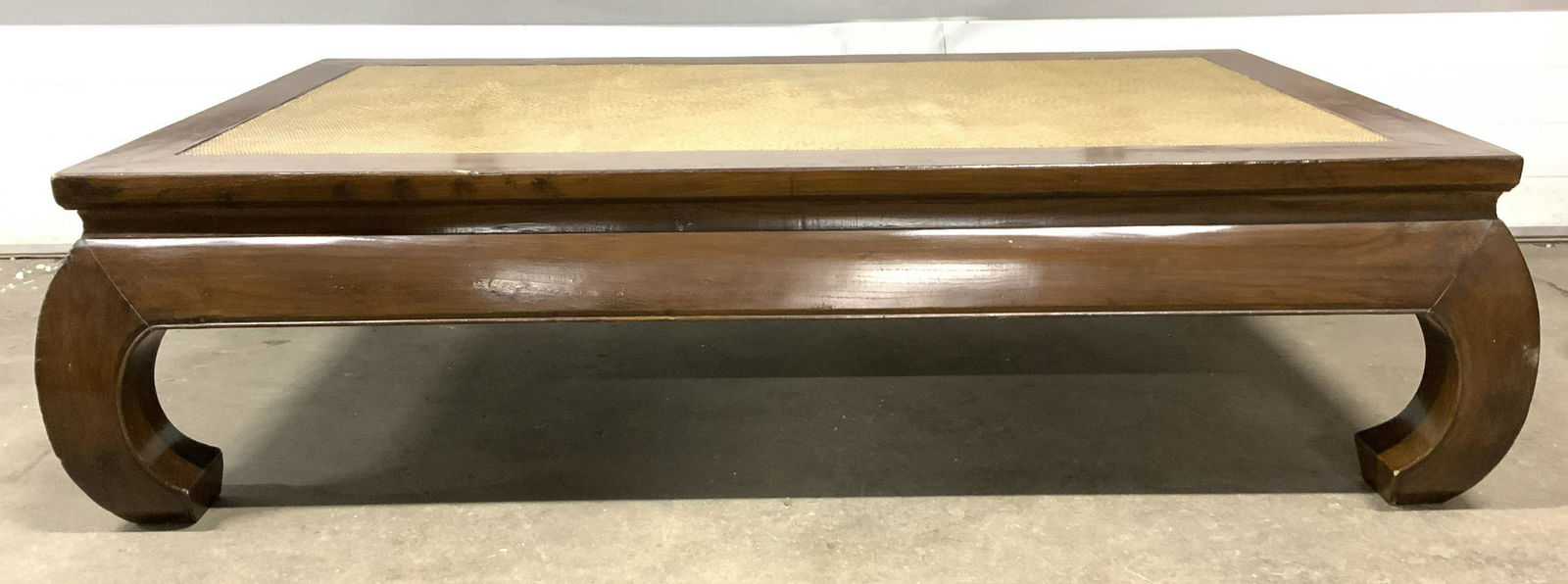 Chinese Ming Dynasty Style Low Wooden Tea Table: Tea table is vintage possibly antique. Piece appears to be solid wood. Table top has detail which mimics woven detail. Each leg curves inward. Tea table, accent table, occasional table, Chinese table,