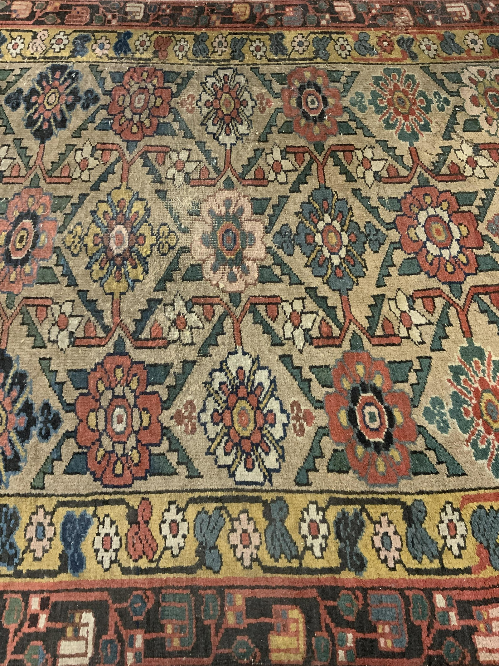 Antique Handmade Floral Detailed Wool Rug: Rug is antique. Piece is wool and handmade. Rug contains intricate multi toned floral and geometric detail. Piece has short fringes. Rug, carpet, area rug, wool rug, handmade rug, vintage rug, antique