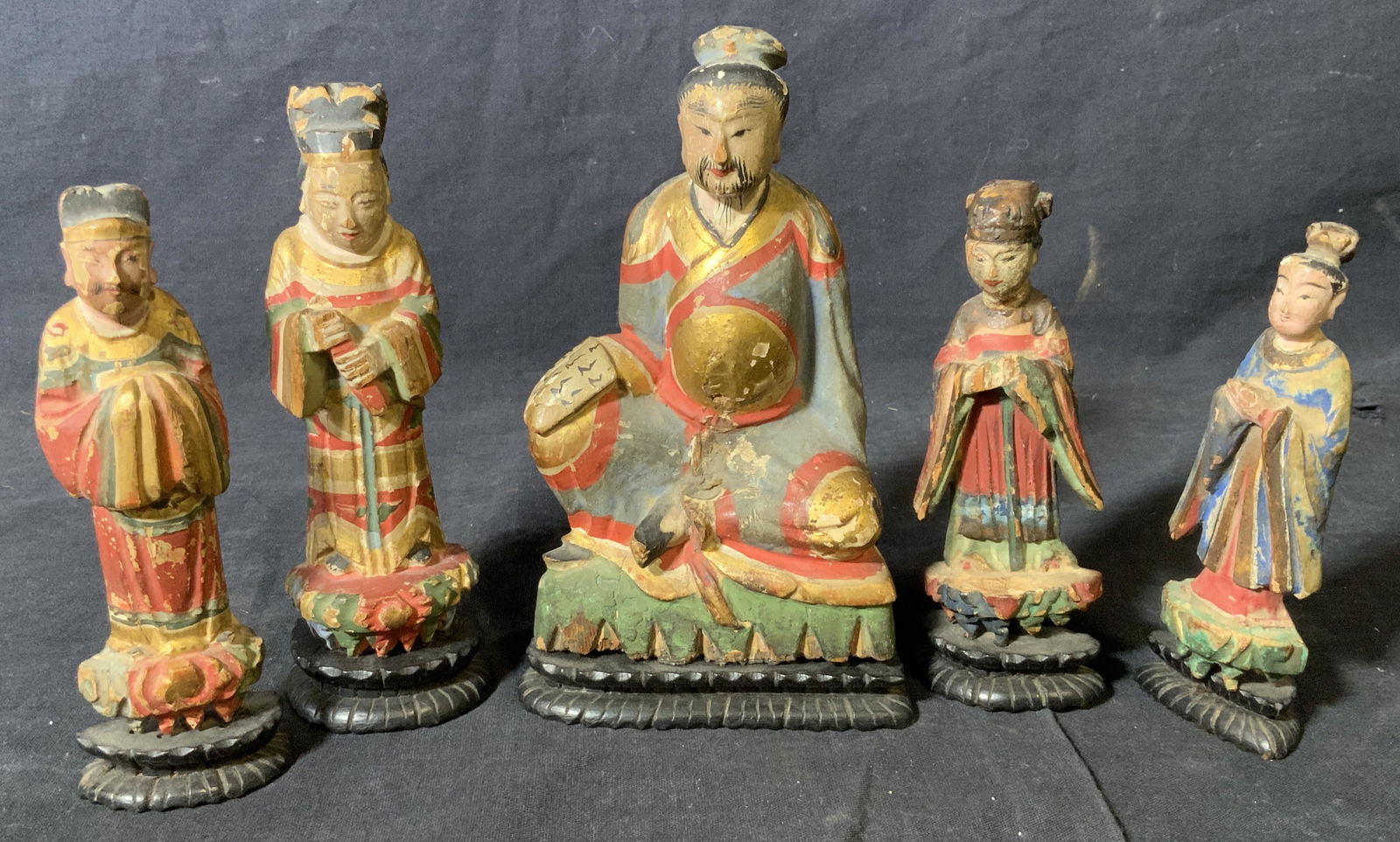 Group Lot 5 Asian Hand Painted Wooden Figurines: Group lot 5 Asian hand painted wooden figurines, possibly made of a light weight wood, each painted in rich colors with gold accents and a black base, each varies in size and style largest of the grou