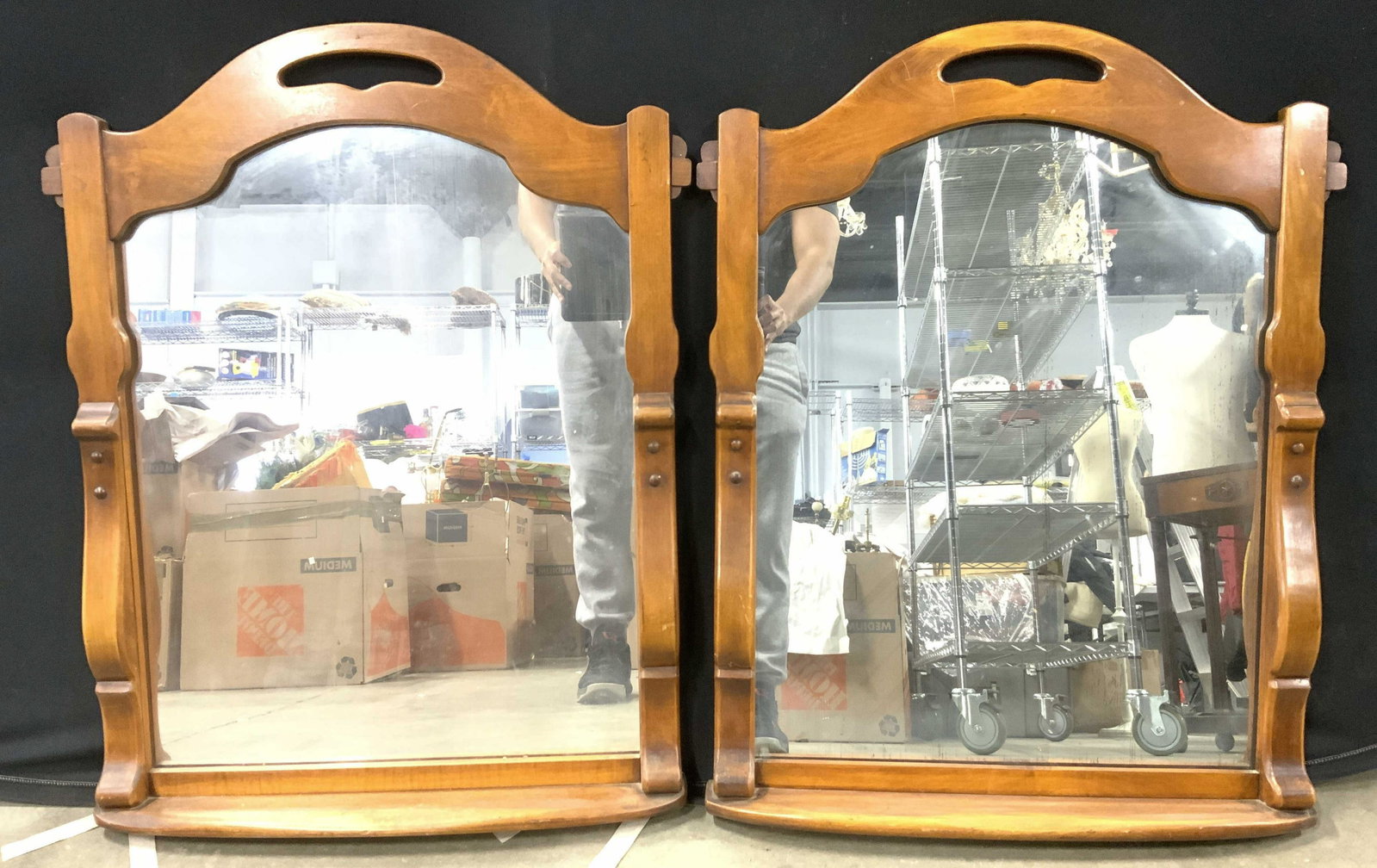 Pair vintage Wooden Wall Mirrors: Mirrors appear to possibly be hand crafted. Top of each piece has negative space detail with appears to be a handle. Each have carved detail. Bases of each have shallow shelf area. Each measures appro