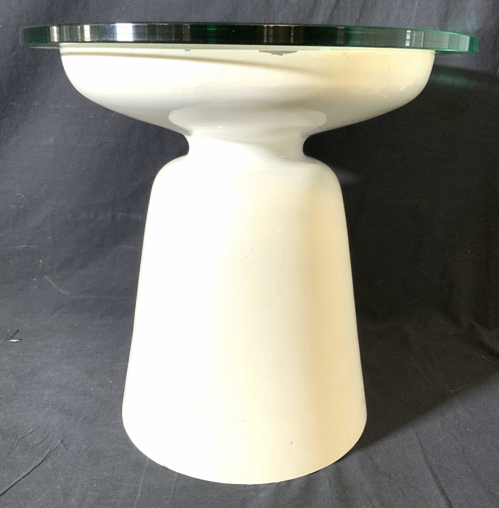 White Toned Metal Side Table W Glass Top: Side table is white toned and appears to be metal. Table top has thick round glass top. Piece when put together measures approx 17 inches tall 18 inches wide. Piece has evident paint chipping & wear. 