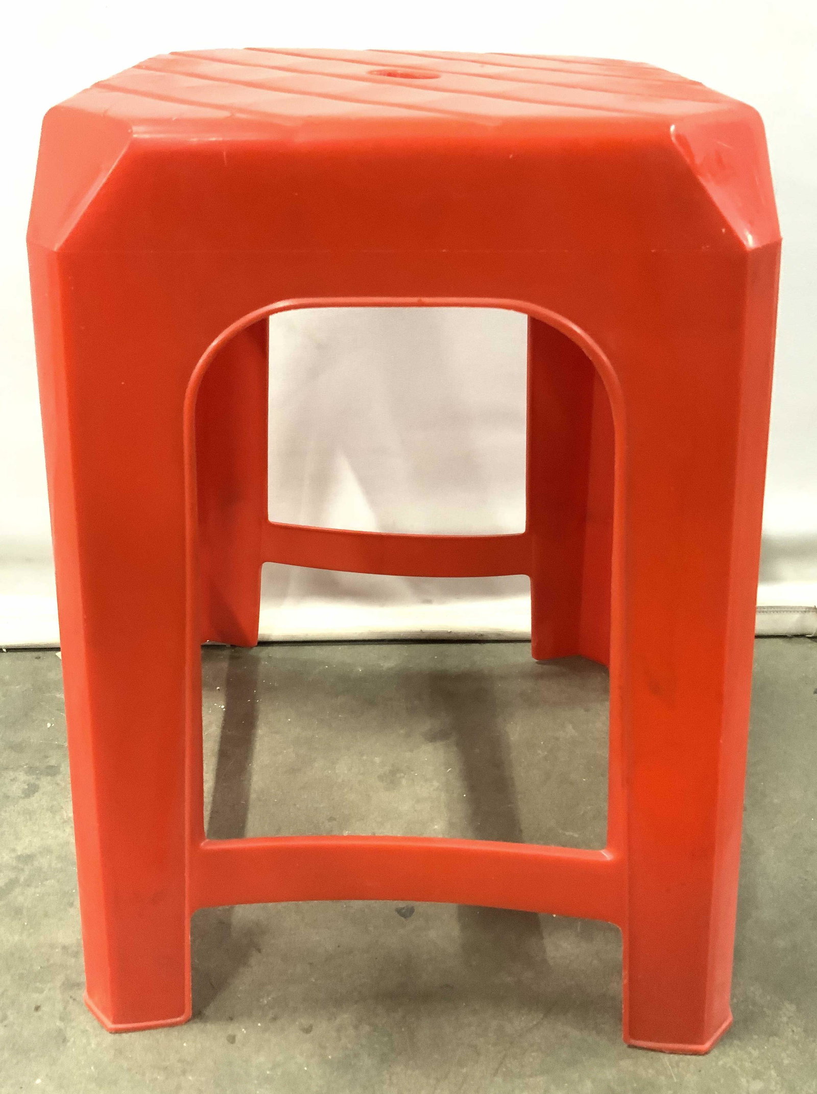Vintage Retro Red Plastic Kitchen Stool: Stool is red toned & appears to be plastic. Center of top has oval shaped negative space. Piece measures approx 18.5 inches tall 14 inches wide & deep. Step stool, stool, bar stool, kitchen stool, kit