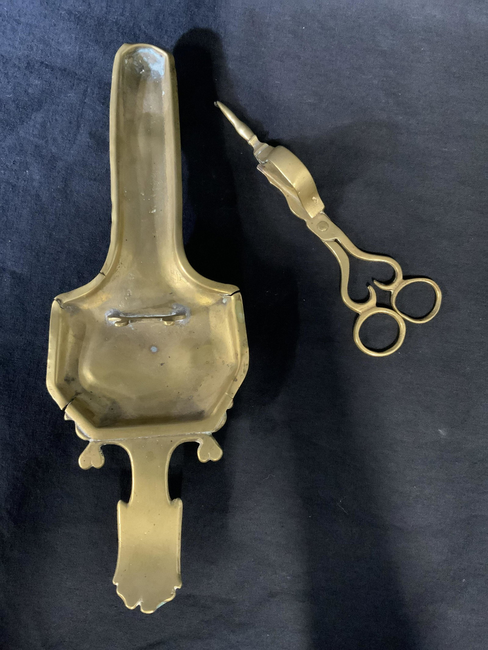 Lot 2 Vintage Brass Accessories: Lot includes two vintage brass accessories. An incense tray, and a wick Snuffer/wick scissors. Largest piece measures approx 10.75 inches long, 3.75 inches W. Wear is consistent with age and use, some