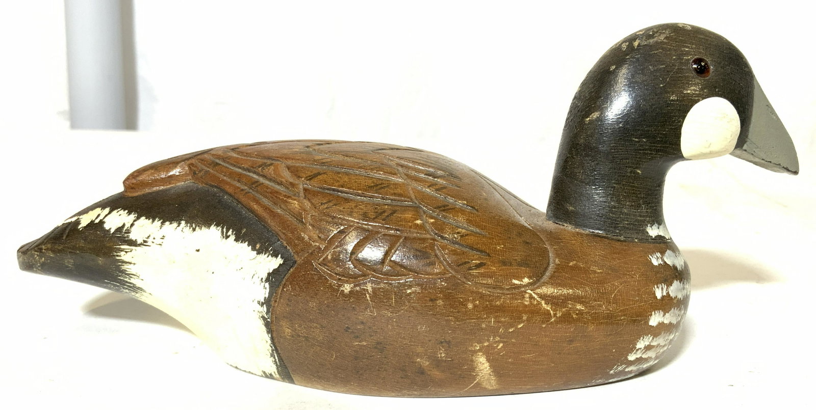 Lot 3 Tabletop Accessories, Duck Figural and More: Lot includes 1 goose decoy, 1 speckled shell, & 1 glass arrowhead. Goose decoy is wooden, appears to be hand painted & hand carved. Arrow head appears to be glass, possibly hand crafted. Duck measures