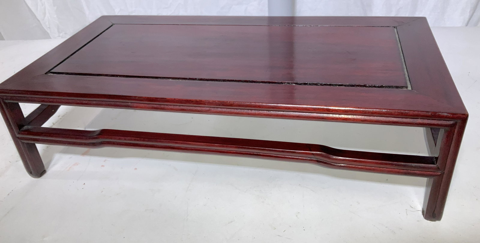Asian Stained Redwood Display Stand: Minimalist rectangular porcelain statue or vase display stand, stained with a reddish varnish . sturdy, hand made , measures 20 in L, 10.25 in wide, 5 in tall. Asian Decorative Arts, Asian Wood Stand,