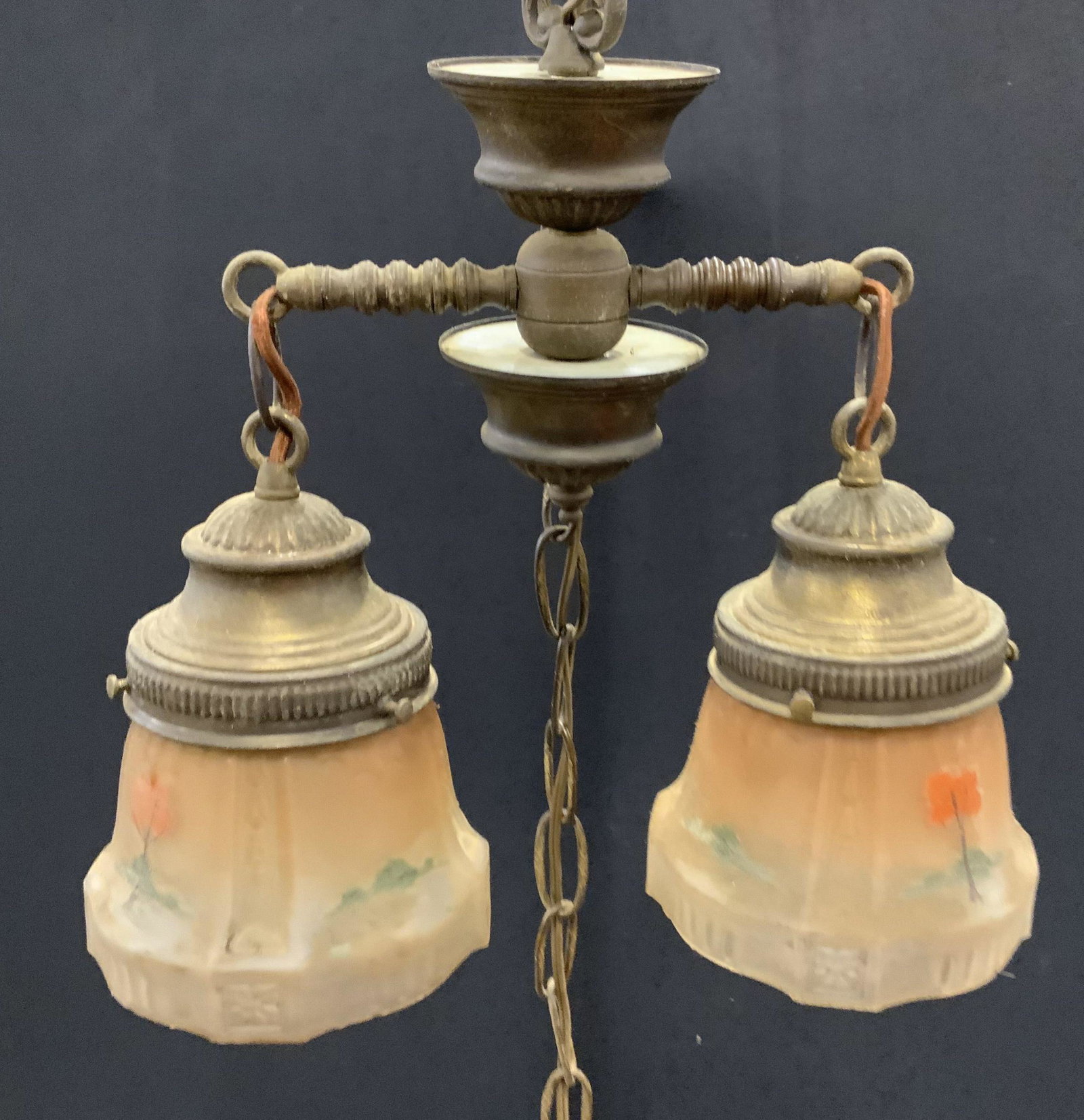Vintage Brass Fixture W Hand Painted Shades: Vintage brass light fixture. Two armed, each socket is equipped with a glass shade, each shade is hand painted, depicting several trees and bushes. Measures approx 13 inches H, and 13.5 inches W. Wear