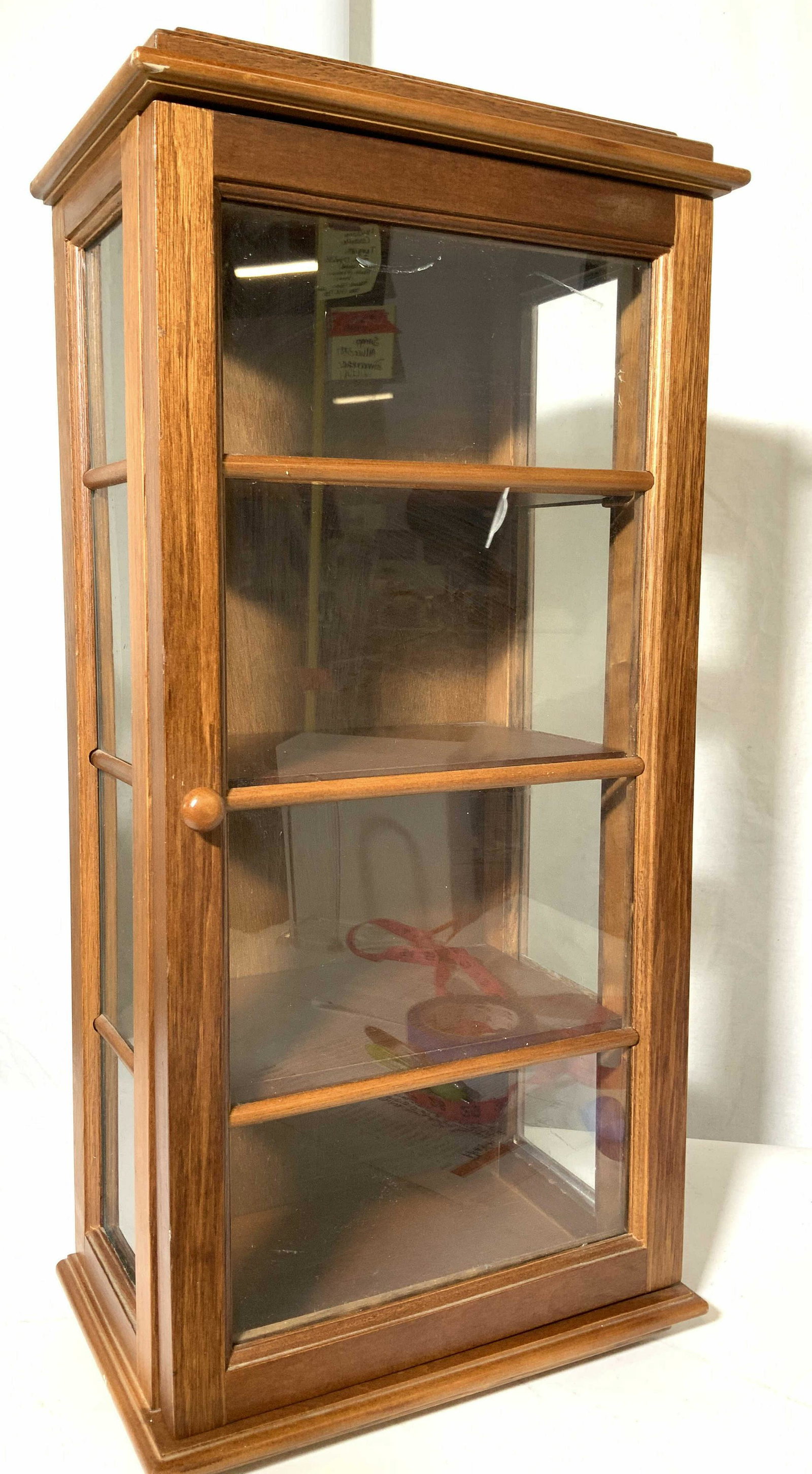 Mission Style Wall or Table Wood Curio Cabinet: Vintage small furnishings, Angular Wood Wall Cabinet, possibly with cherry wood stain, for display items. Mission style design with attached pull open door. Interior backside plywood, hinged door with