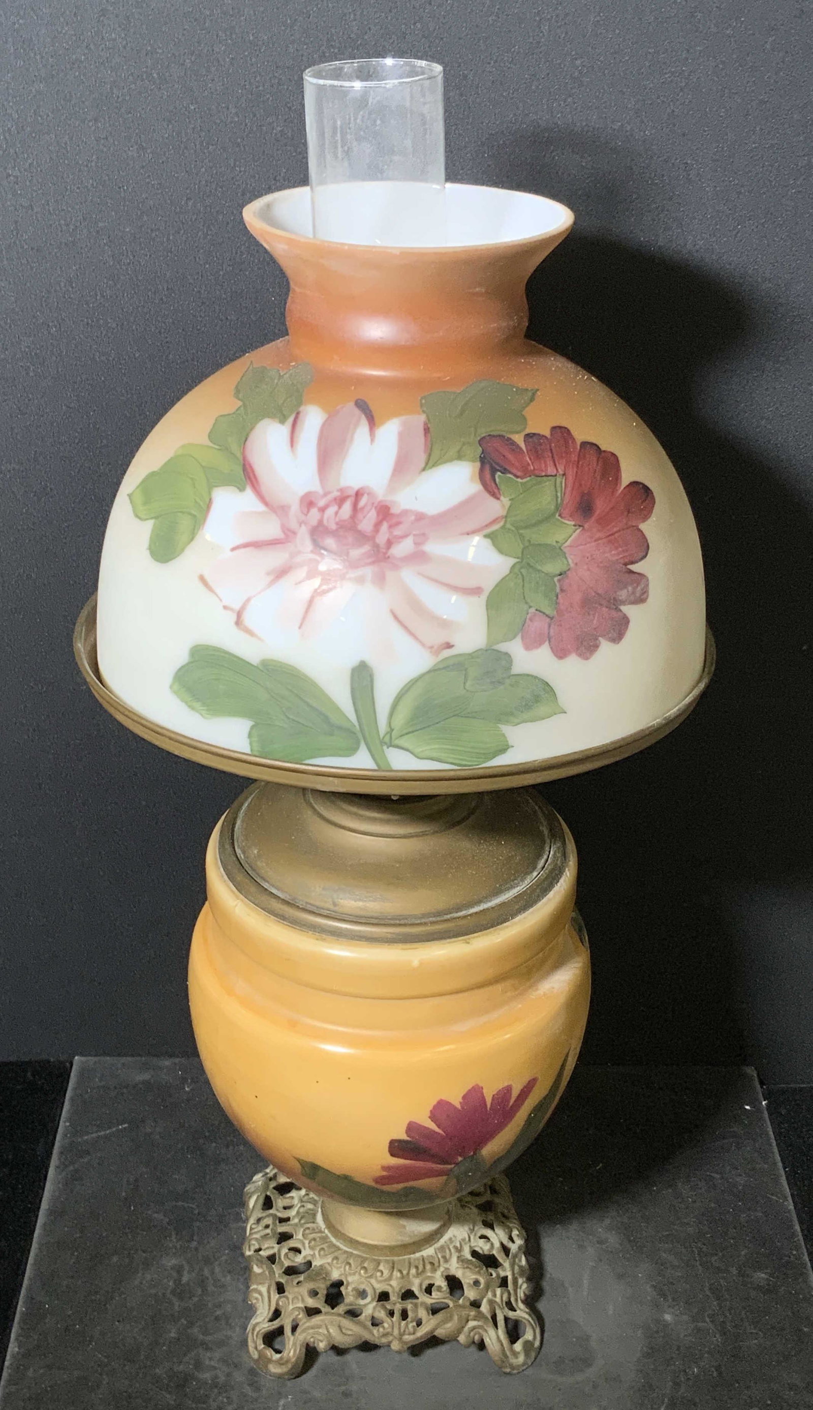 Vintage Gone With The Wind Style Floral Glass Lamp: This vintage Gone With The Wind style lamp is crafted from thick walled glass and metal. Possibly bronze. Piece features hand painted floral designs throughout. The base is footed and has etched & pie
