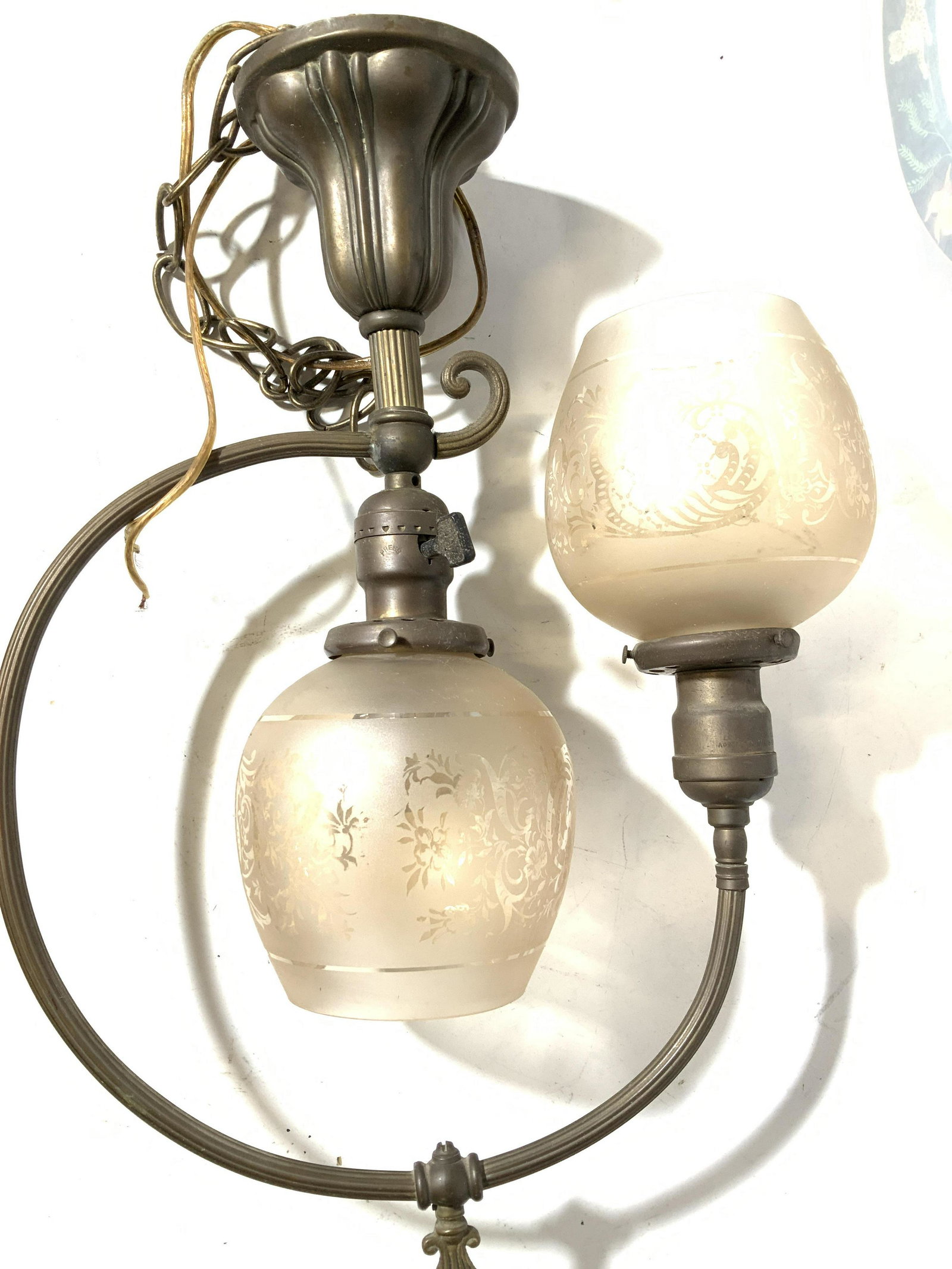 Early American Bistro Deux Pendant Light: Vintage, possibly antique, bistro light with two etched globe shades , a combination of clear and frosted colored glass. Bronze toned metal hardware with ceiling plate, copper wiring, hang chain, turn
