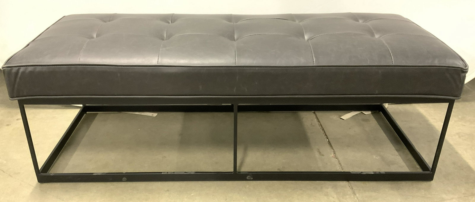 Tufted Leather Bench W Metal Base: Bench has tufted seat. Upholstery is in the style of real leather. Base is black toned and metal. Piece measures approx 49 inches long 17 inches tall 20 inches deep. Bench, tufted bench, low bench, ho