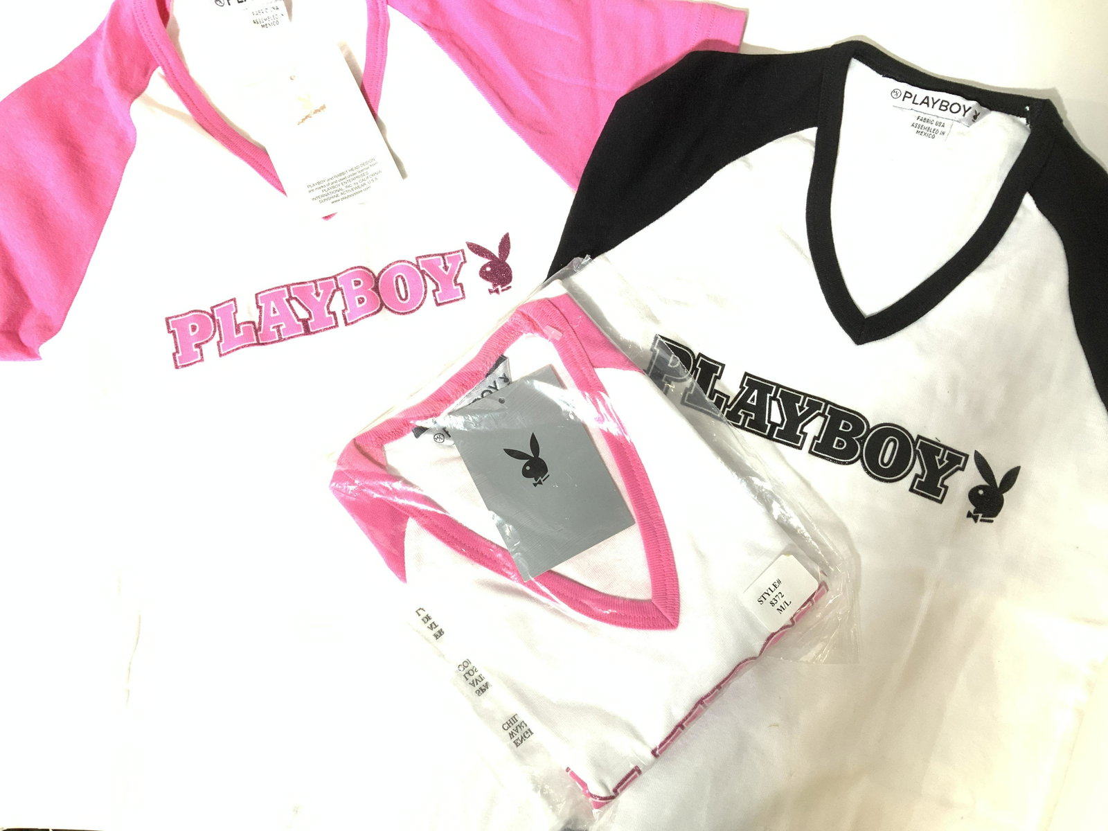 3 PLAYBOY RABBIT HEAD Ladies T shirts, tags: Baseball style Rabbit Head design Playboy T shits, two pink and white, one black and white, xtra small with v neck collar. One in package size M/L, other with tag attached. Playboy enterprise license.