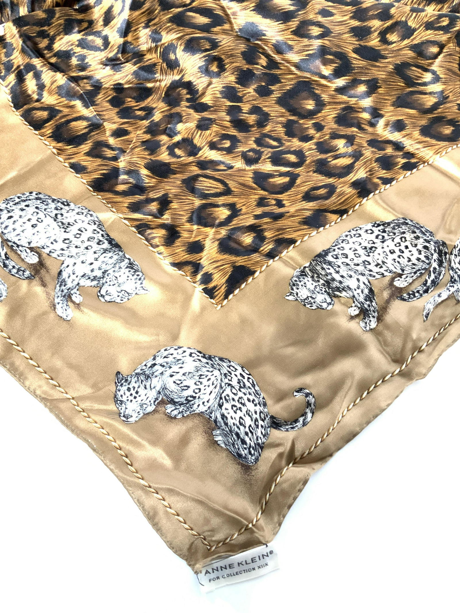 Signed ANNE KLEIN SILK Jungle Print Scarf: Anne Klein’s Collection XIIX, designer labeled, 100% silk, Ann Klein coin with logo Lion attached, made in Japan. 36.5 x 34.5 in. Center black and brown animal print with border Jungle cat. Jaguar.