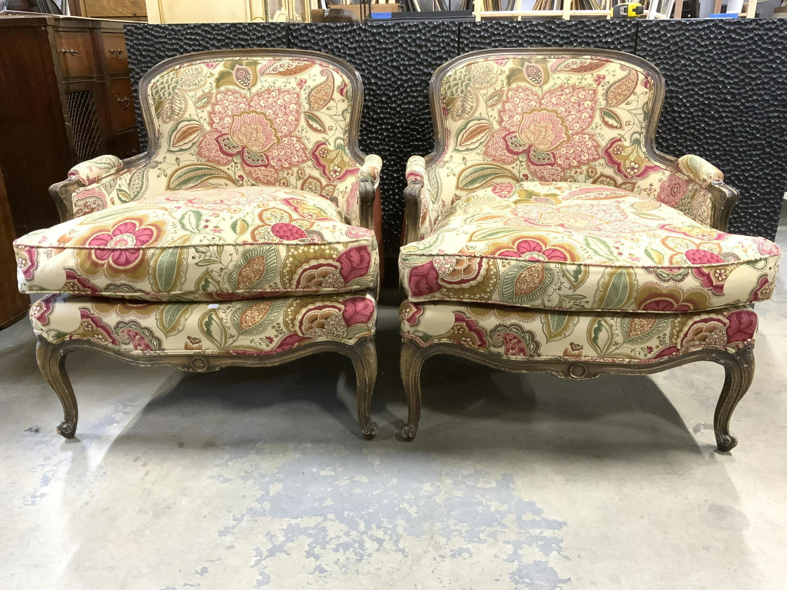 Pair Vintage Upholstered Victorian Style Bergeres: Lot includes 2 Bergeres. Each have intricately detailed floral, leaf, & geometrically detailed upholstery. Some edges of upholstery have double welting. Armrests have upholstered areas. Chair frames h