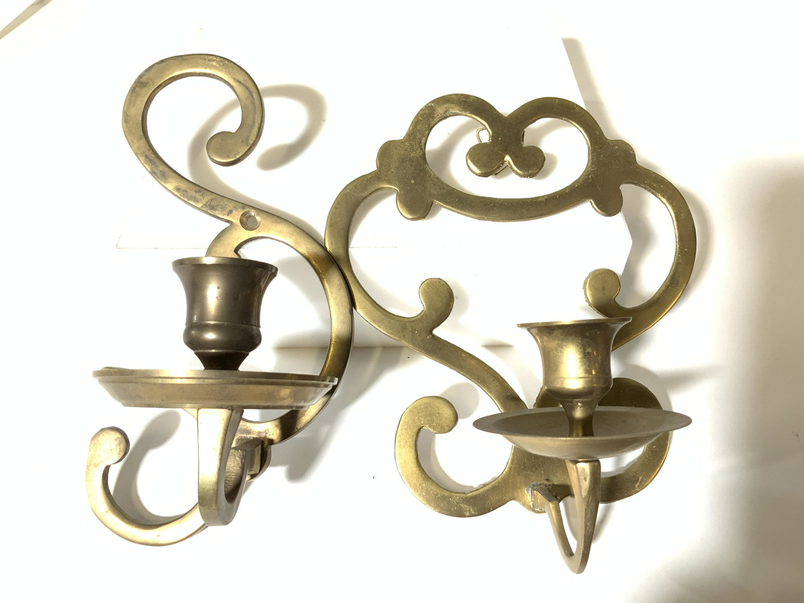 Pair Brass Candlestick Wall Sconces , Vntg: Near pair brass candlestick wall sconces with pierced scroll design. Larger measures 6.5 in ht, 5.75 in width. Depth 3.5 in. Brassware, home decor and accessories, wall decor, brass candle sconces, vi