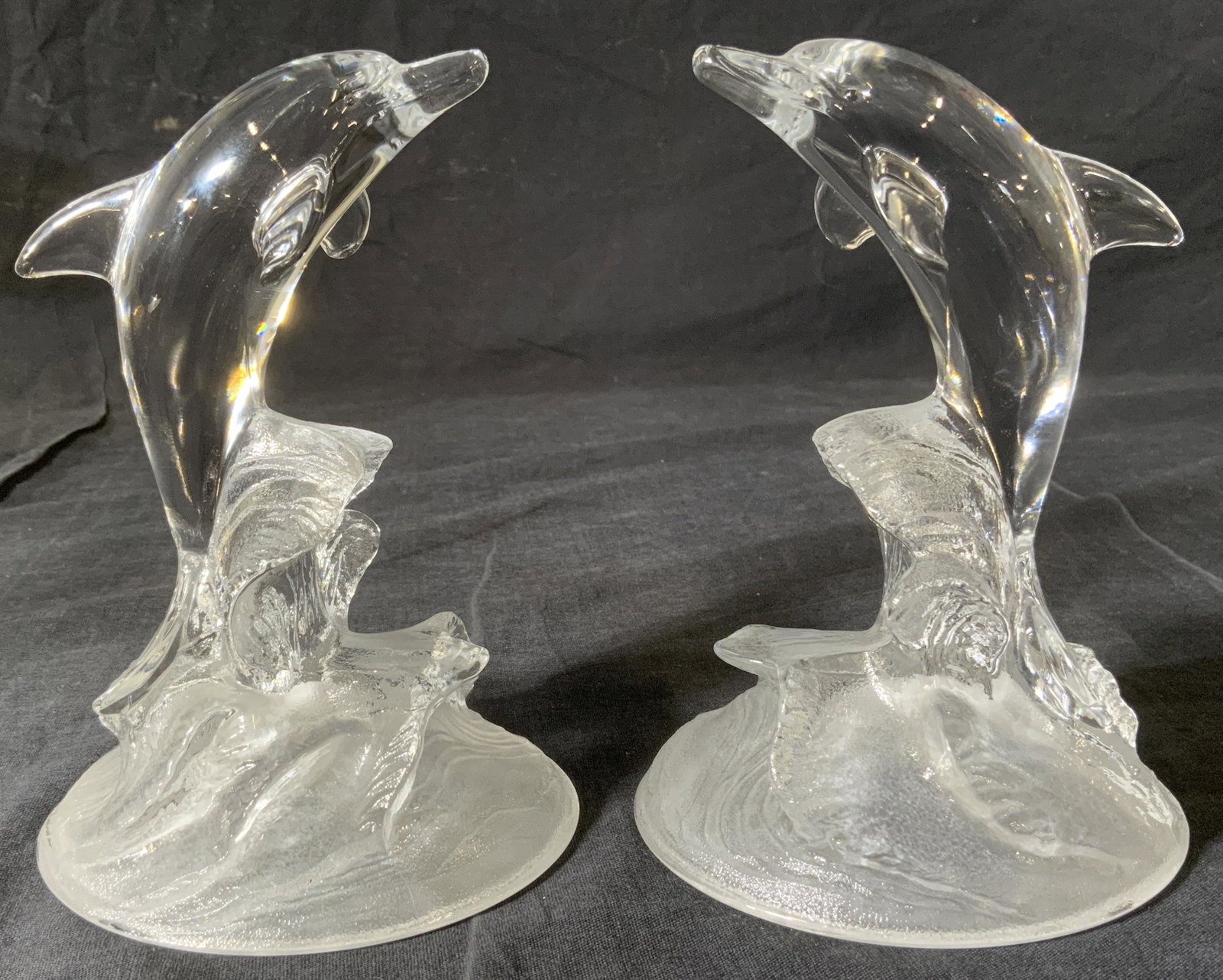 Pair Glass Dolphin Sculptures: Pair Glass Dolphin Sculptures, no apparent inscriptions or marks, dolphins leaping out of waves, both measure 6 1/4 inches tall x 4 1/2 inches wide at base, some surface wear to pieces, Pair, glass, s